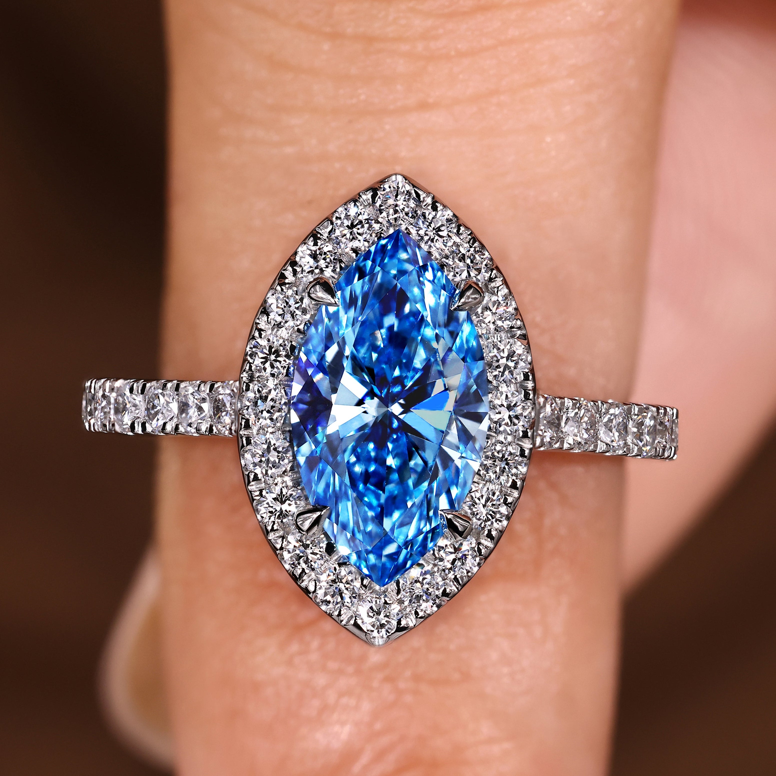 Marquise cut diamond ring with blue center diamond halo
