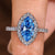 Marquise cut diamond ring with blue center diamond halo
