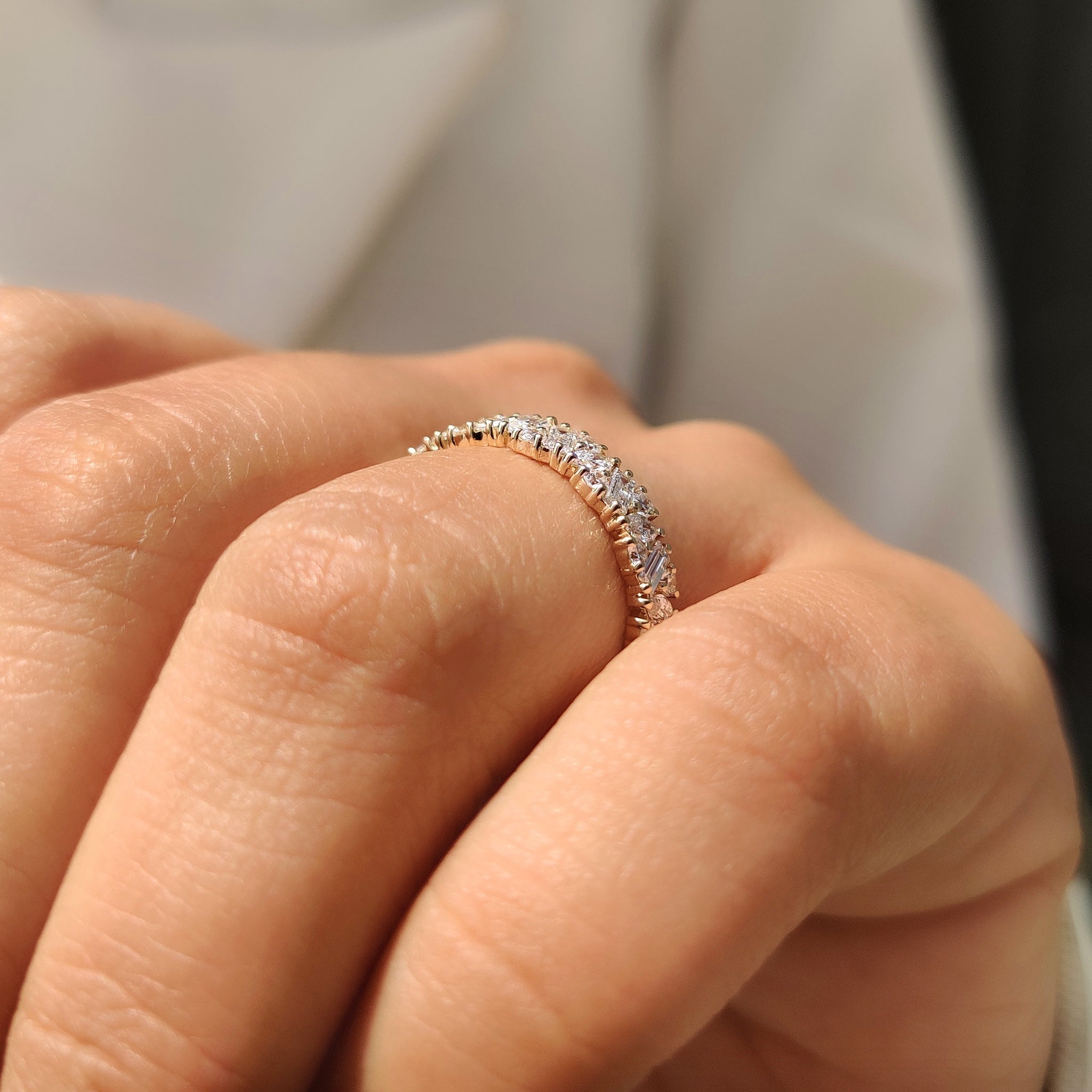 Prong set eternity band with mixed diamond cuts.
