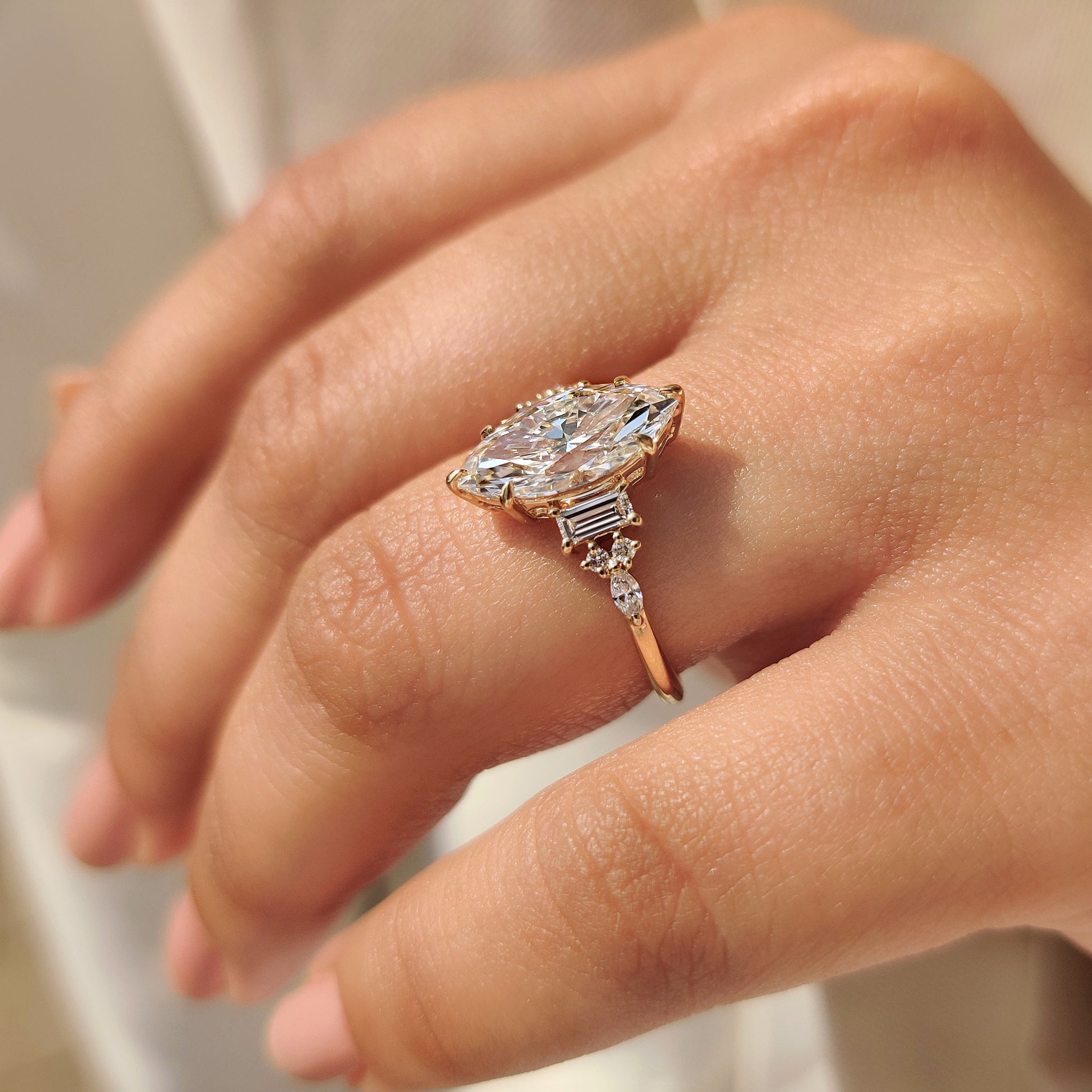 Marquise diamond ring with baguette marquise round side stones.
