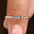 Baguette wedding band with half bezel solitaire diamond setting
