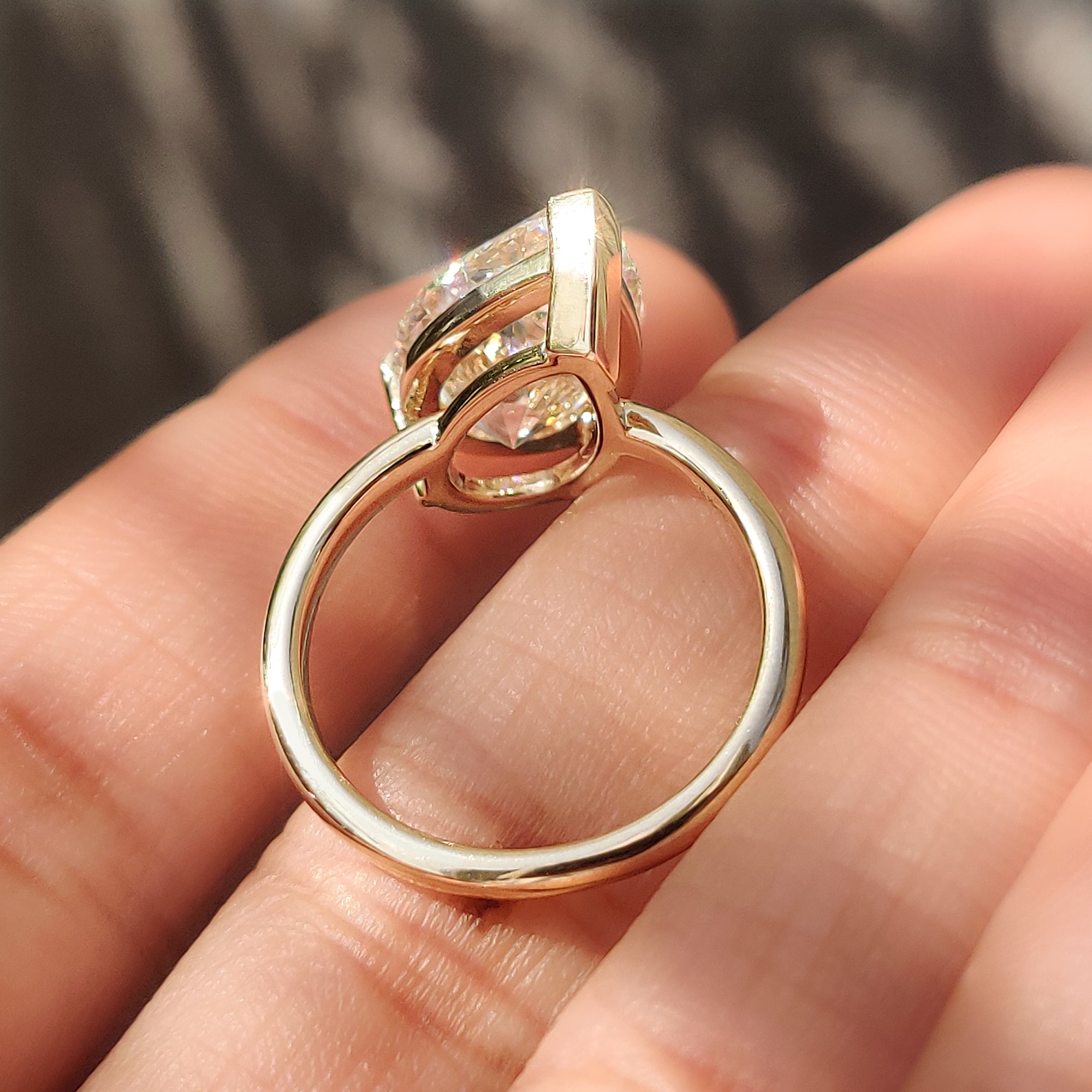 Open gallery basket setting on a pear cut solitaire ring.
