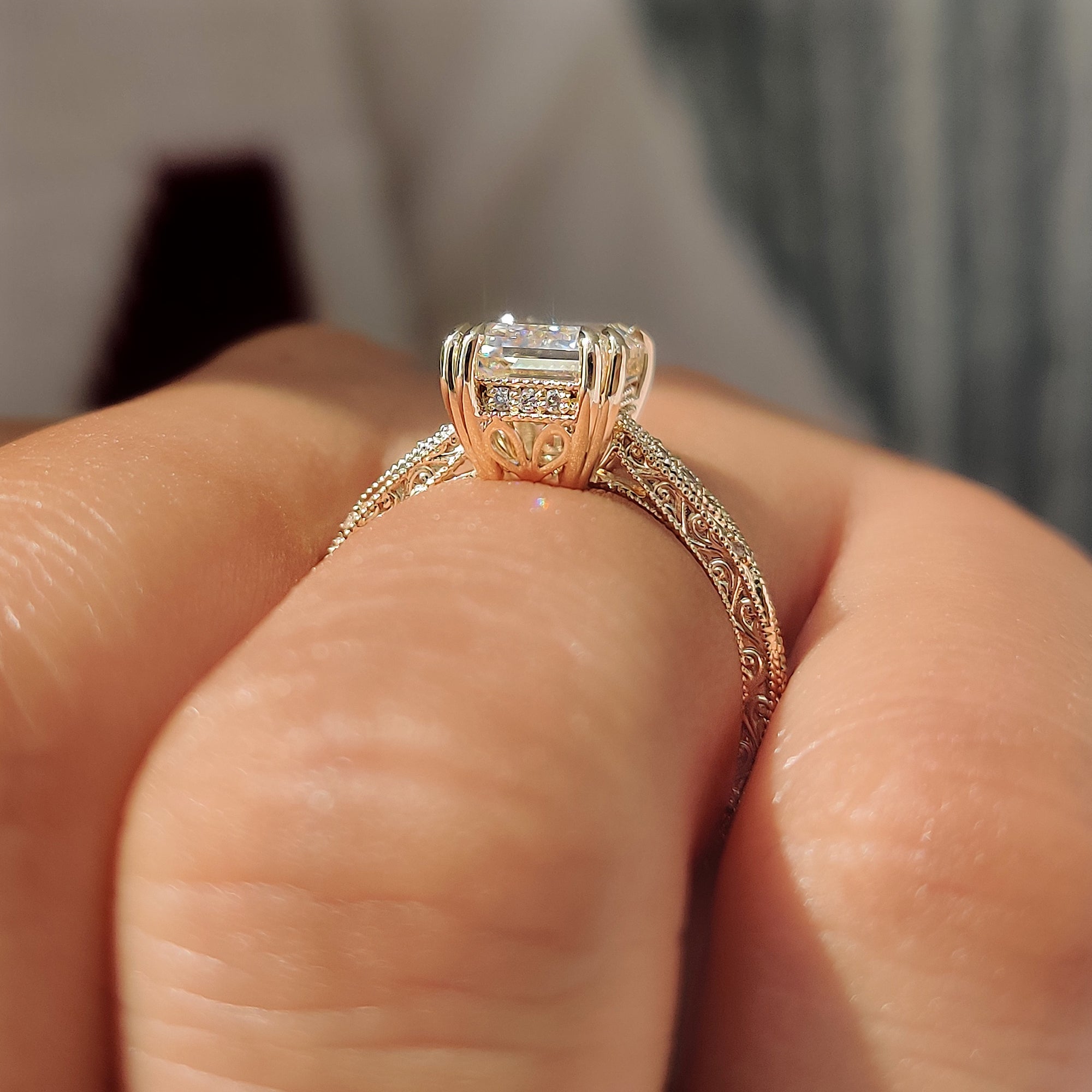 Emerald ring with round pave and filigree shank.
