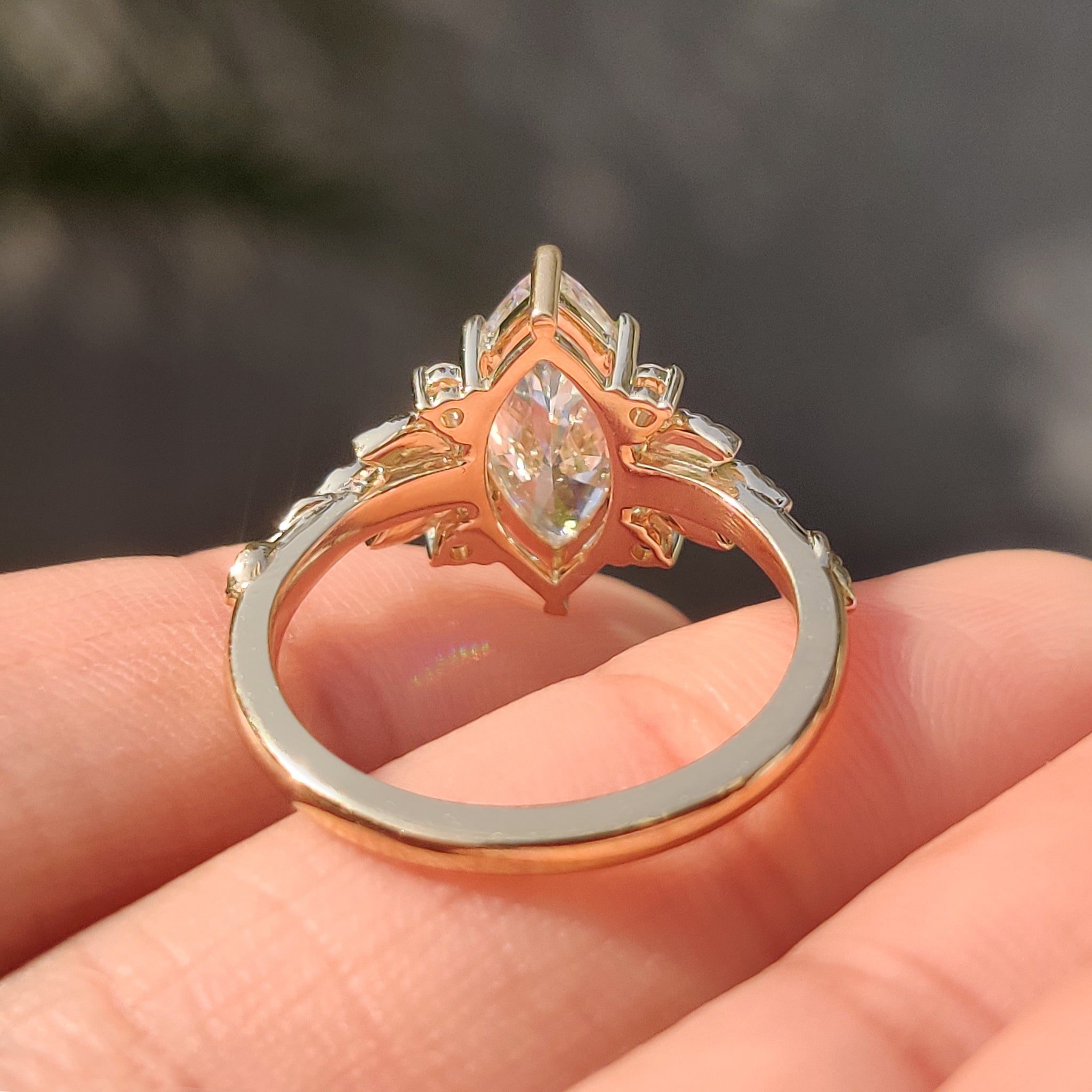 Handmade leaf design ring with marquise diamond center stone.
