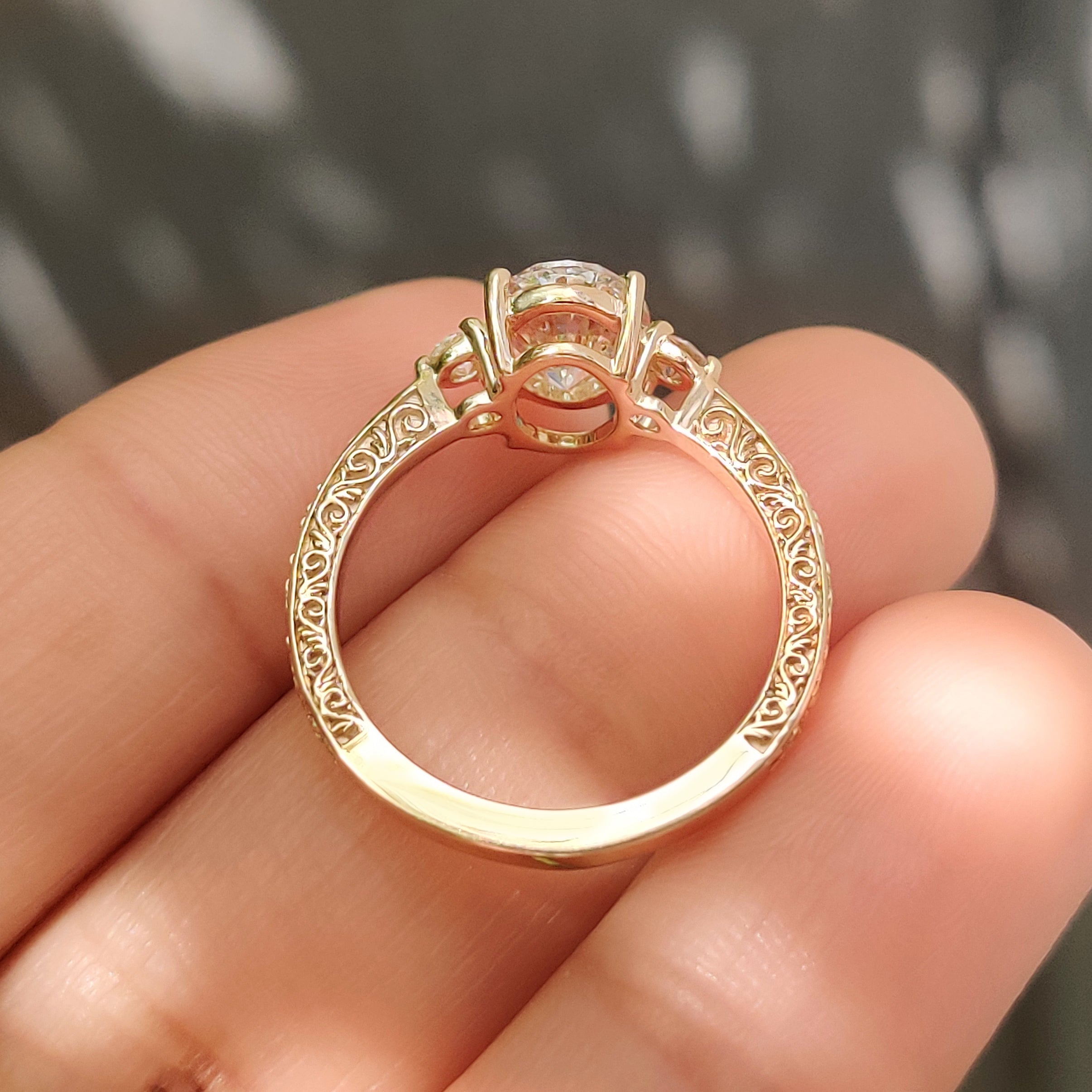 Three stone ring with oval and round diamonds.
