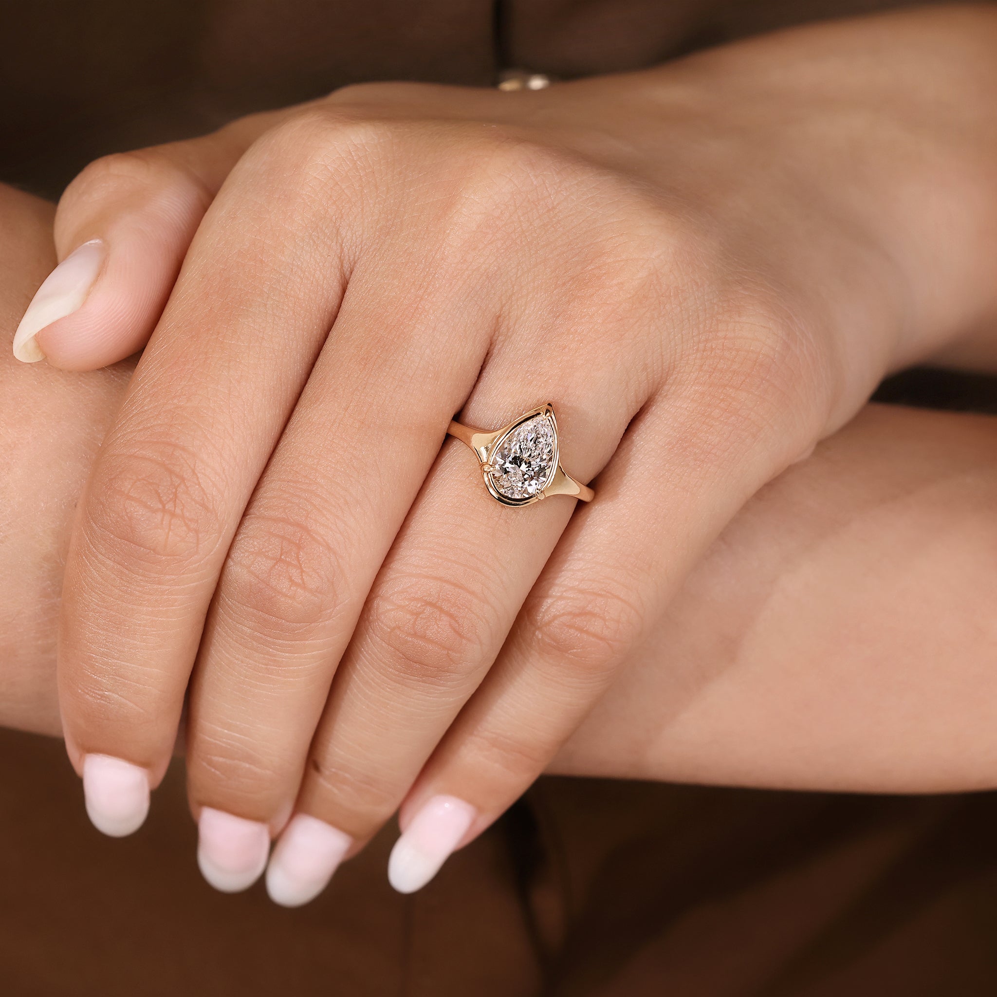 Tapered shank pear cut diamond ring with solitaire setting.
