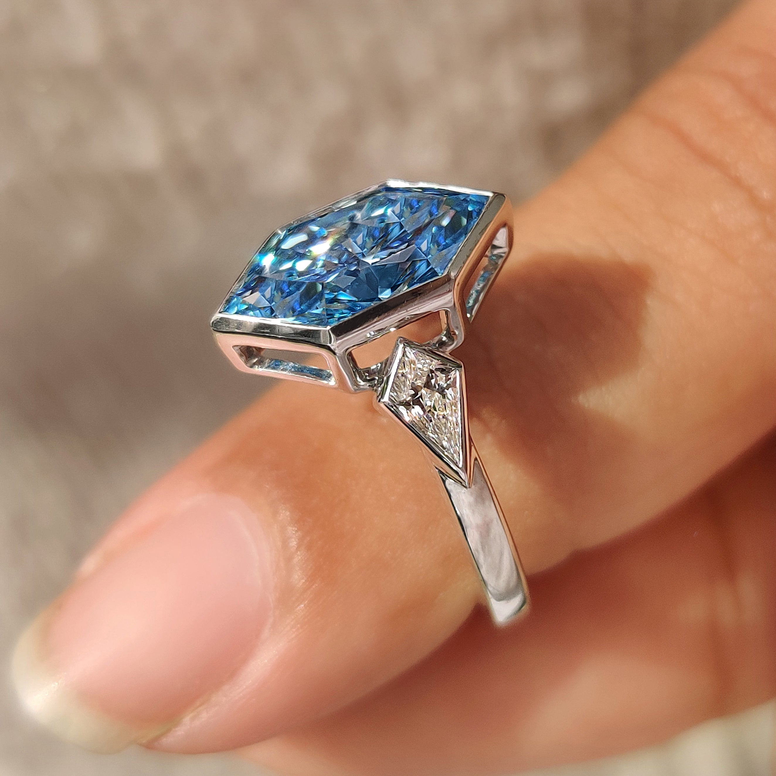 IGI certified three stone engagement ring with blue dutch marquise diamond

