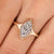 Marquise diamond engagement ring with tapered shank band.
