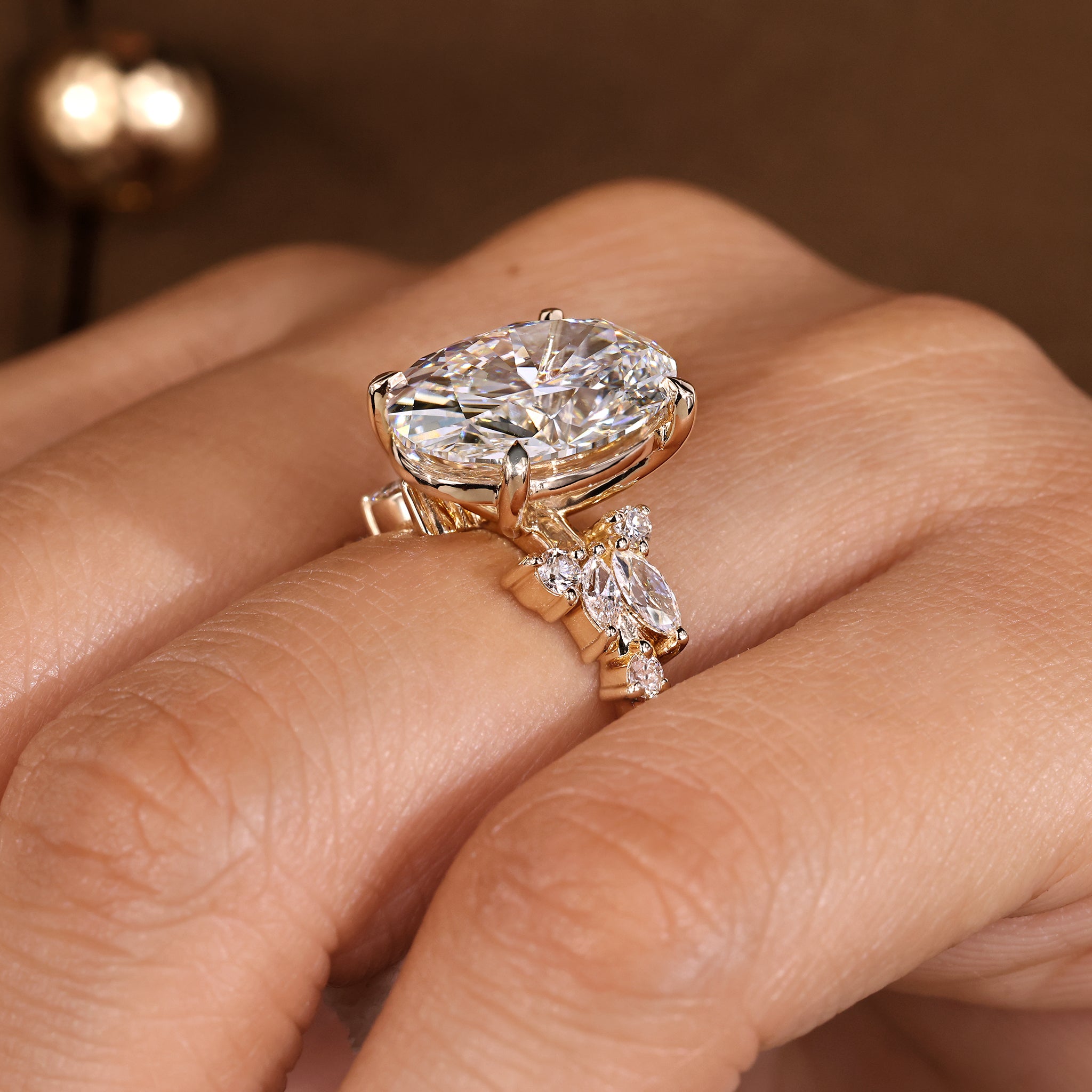 Statement oval cut diamond ring by Carat Diamonds with mixed shape cluster accents.
