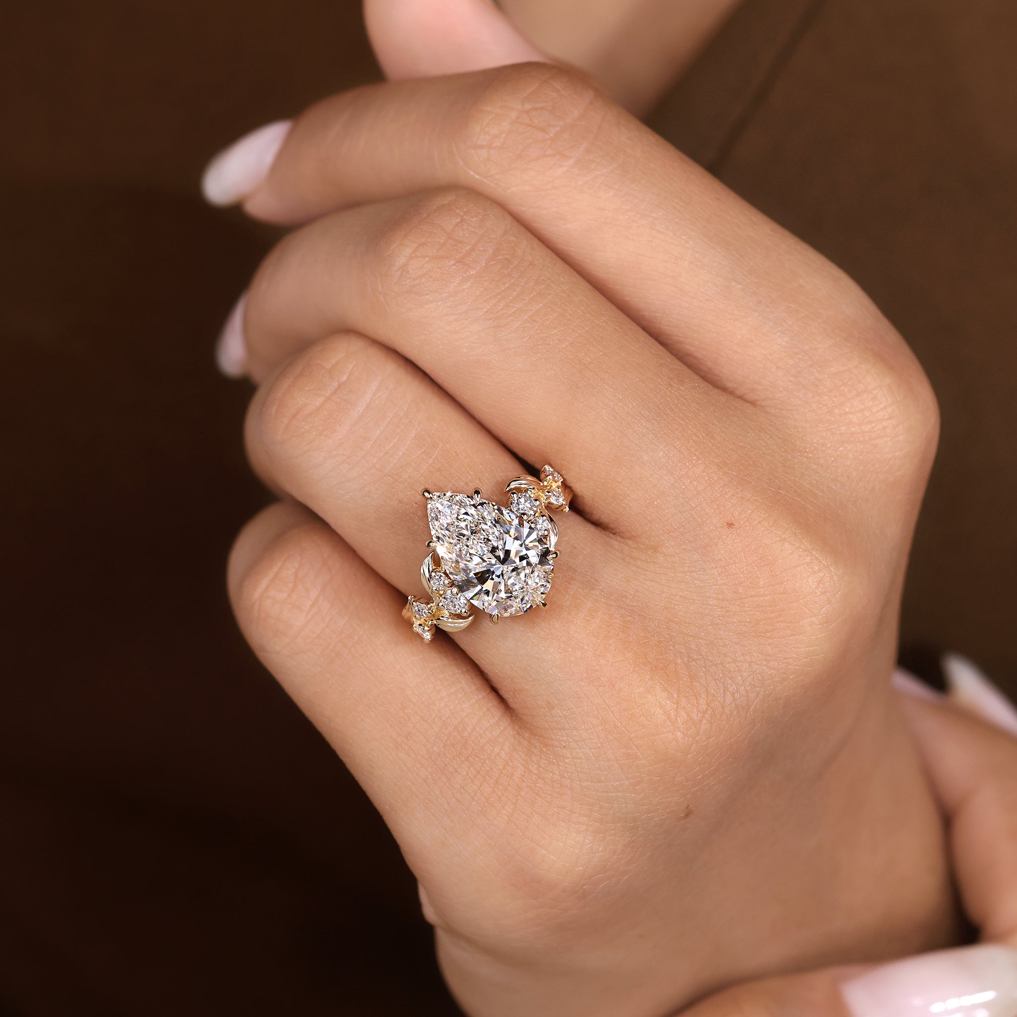Nature inspired pear shaped diamond ring with six claw prong setting
