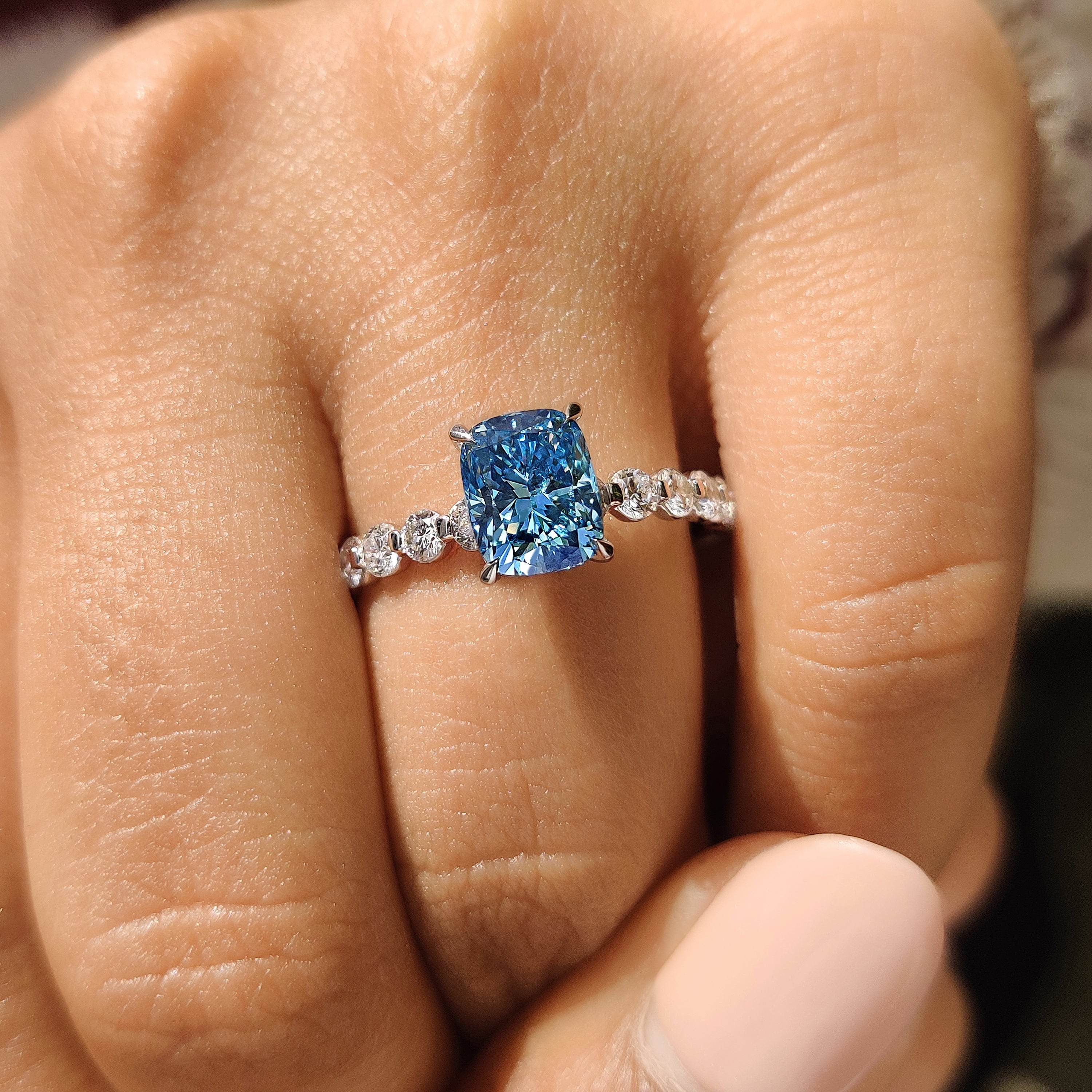 Handmade blue cushion diamond ring design.
