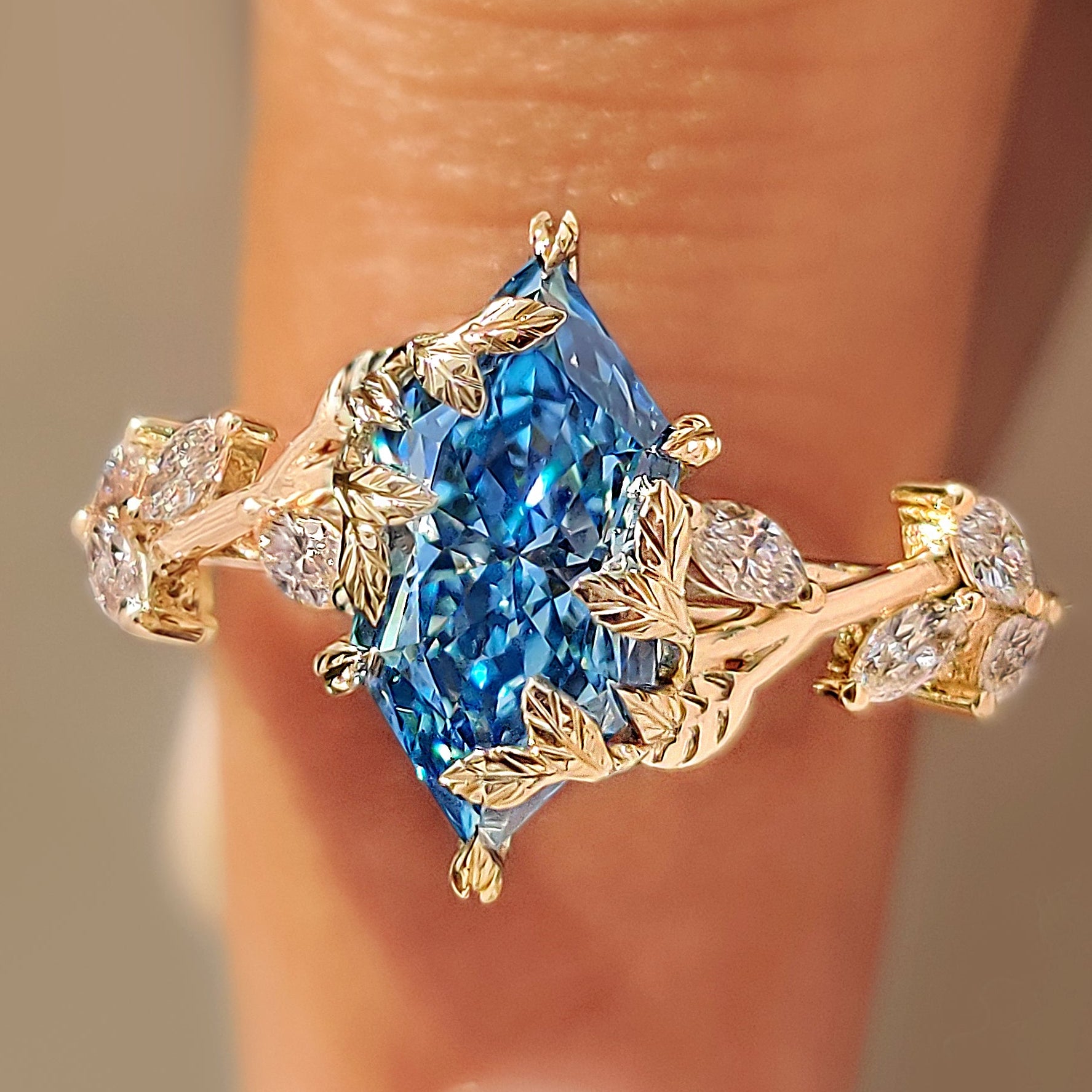 Blue Dutch marquise ring with leaf and vine details.
