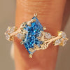 Blue Dutch marquise ring with leaf and vine details.
