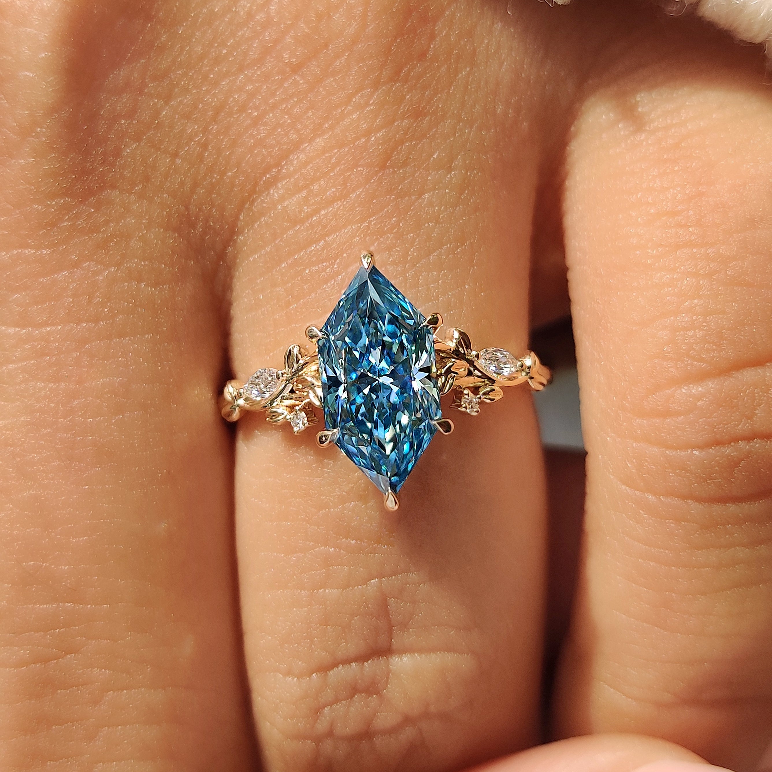 Blue marquise diamond ring with marquise and round accents
