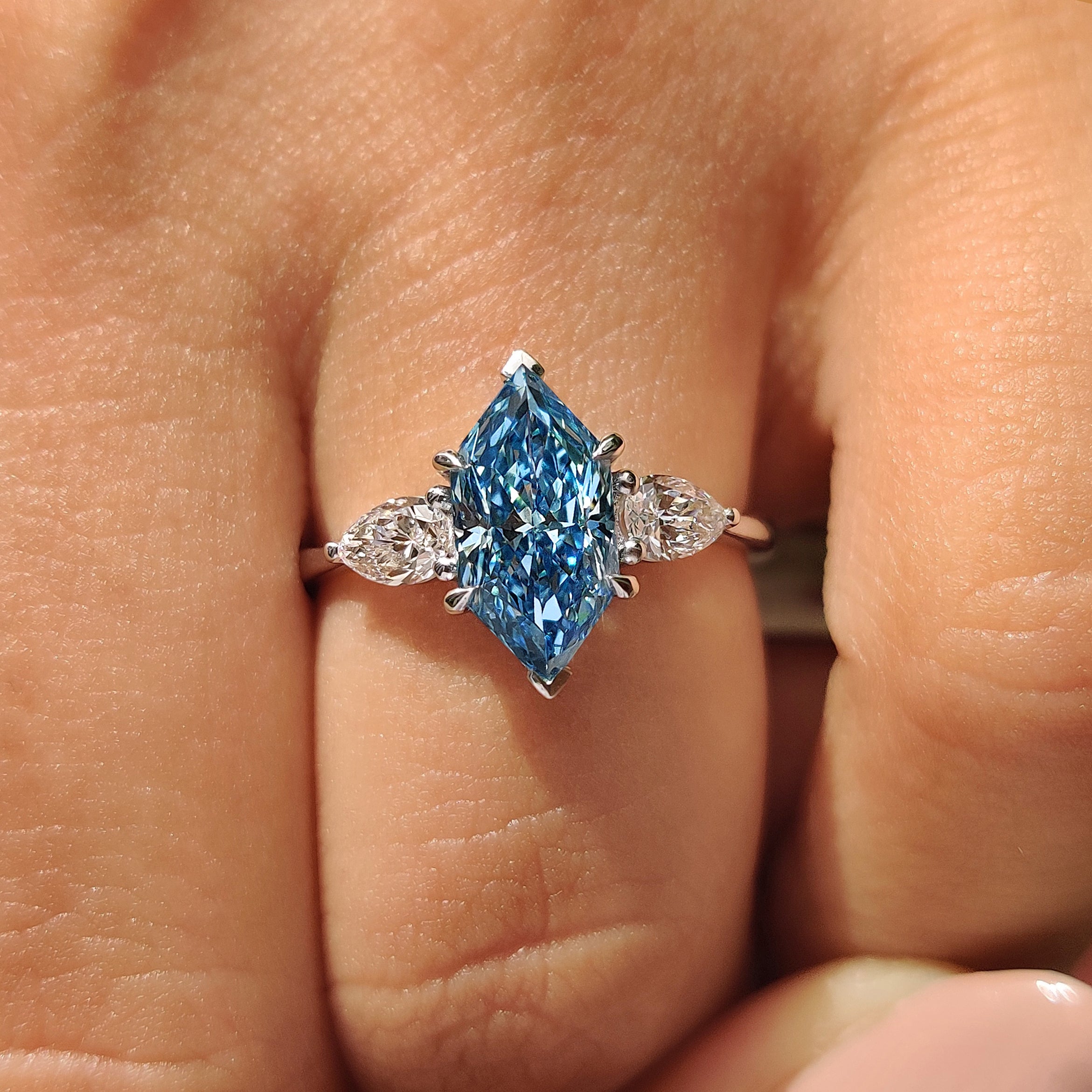 Cathedral setting paired with blue dutch marquise center diamond
