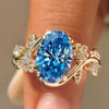 Oak leaf and acorn ring with green oval cut diamond.

