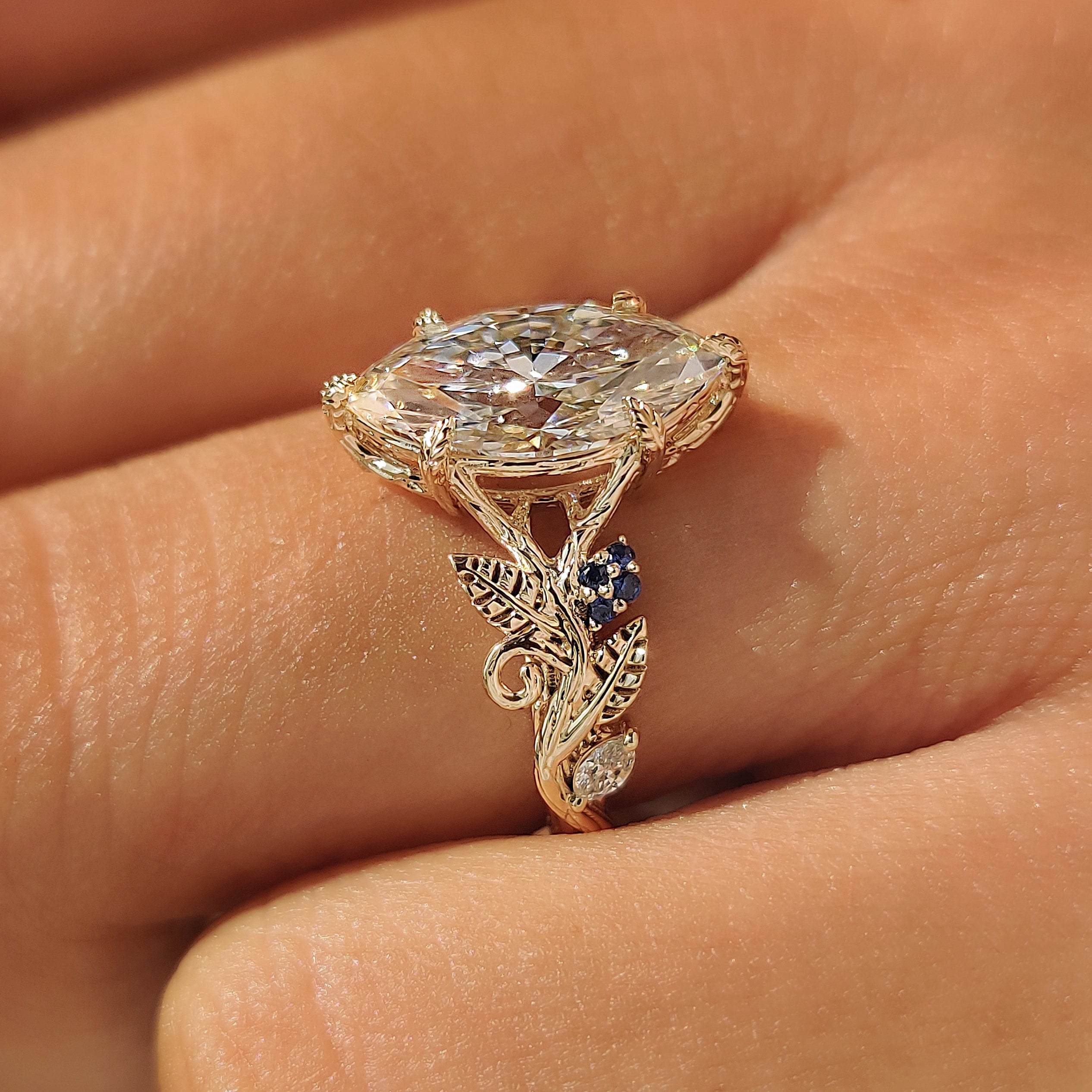 Marquise side stones beside the marquise cut lab grown diamond.
