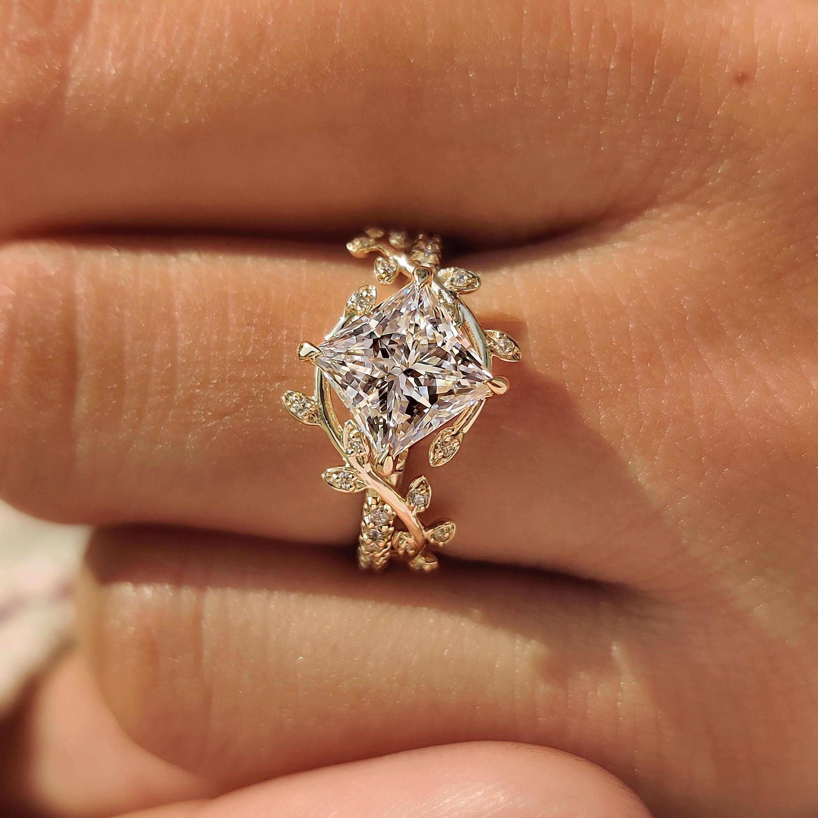 Leaf and vine bypass shank on a princess cut engagement ring.
