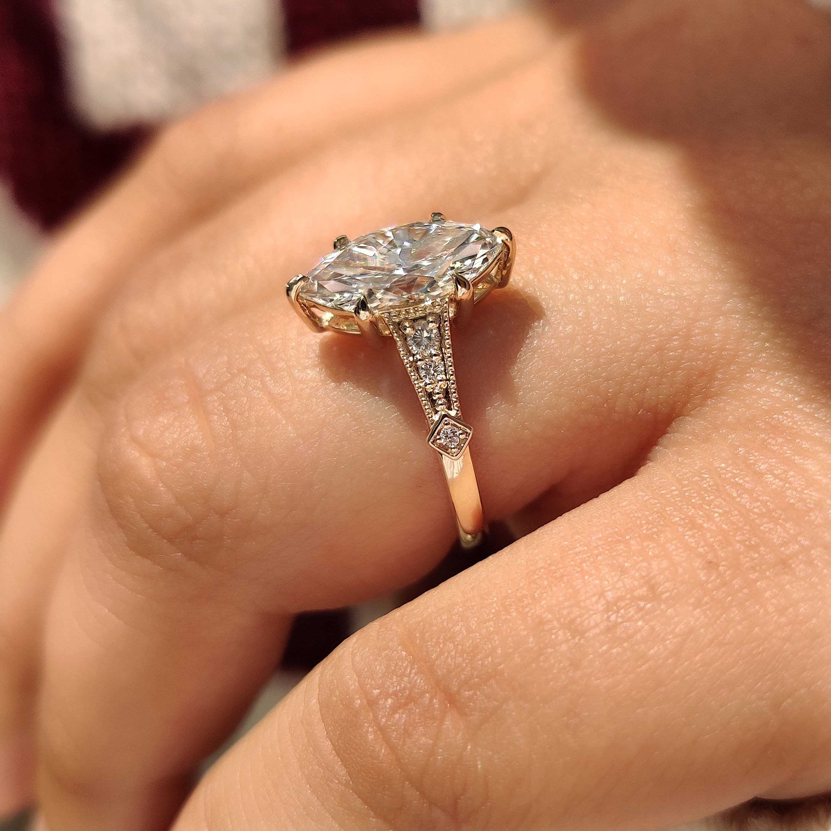 Vintage style marquise diamond ring with round side stones.
