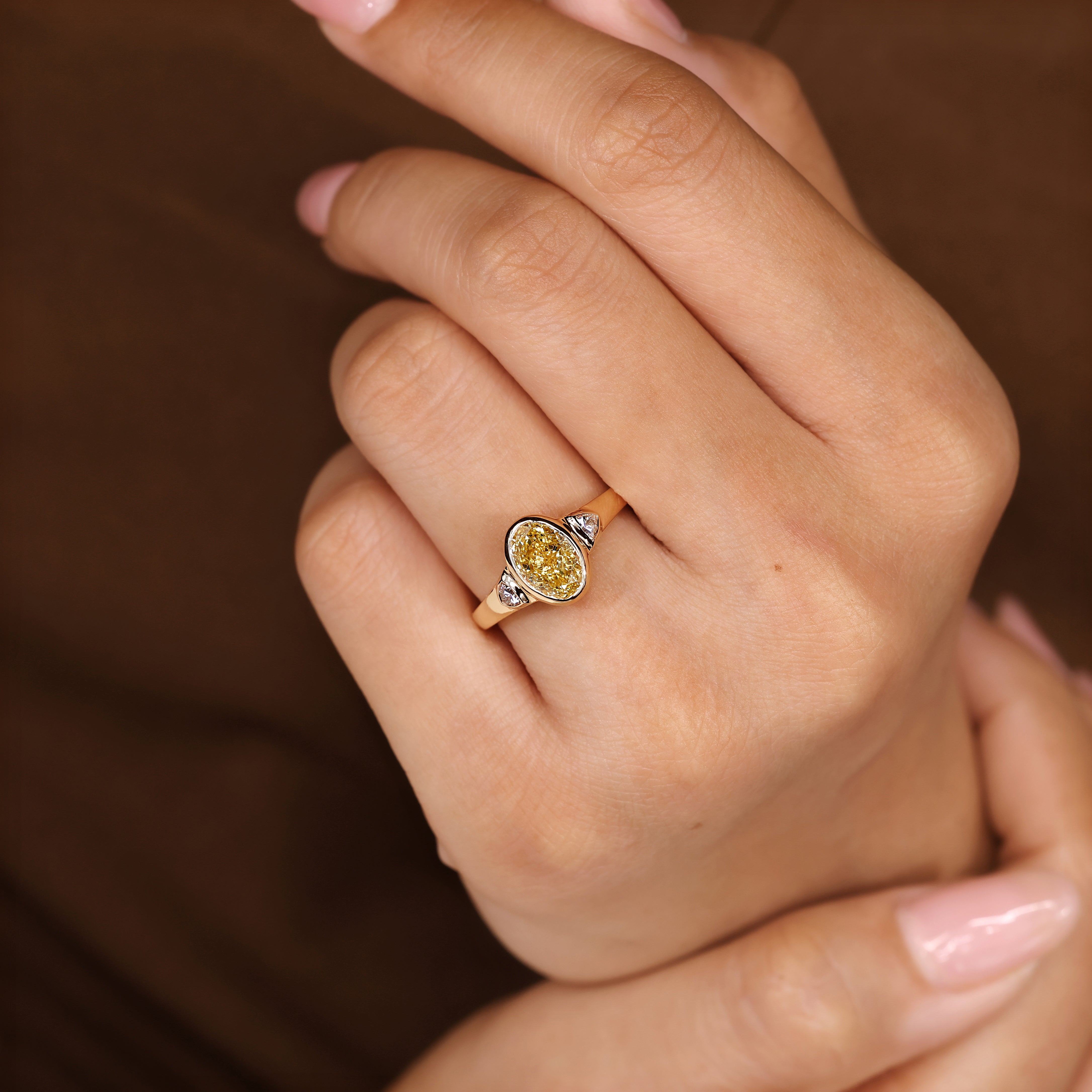Oval cut diamond ring with tapered shank and bezel
