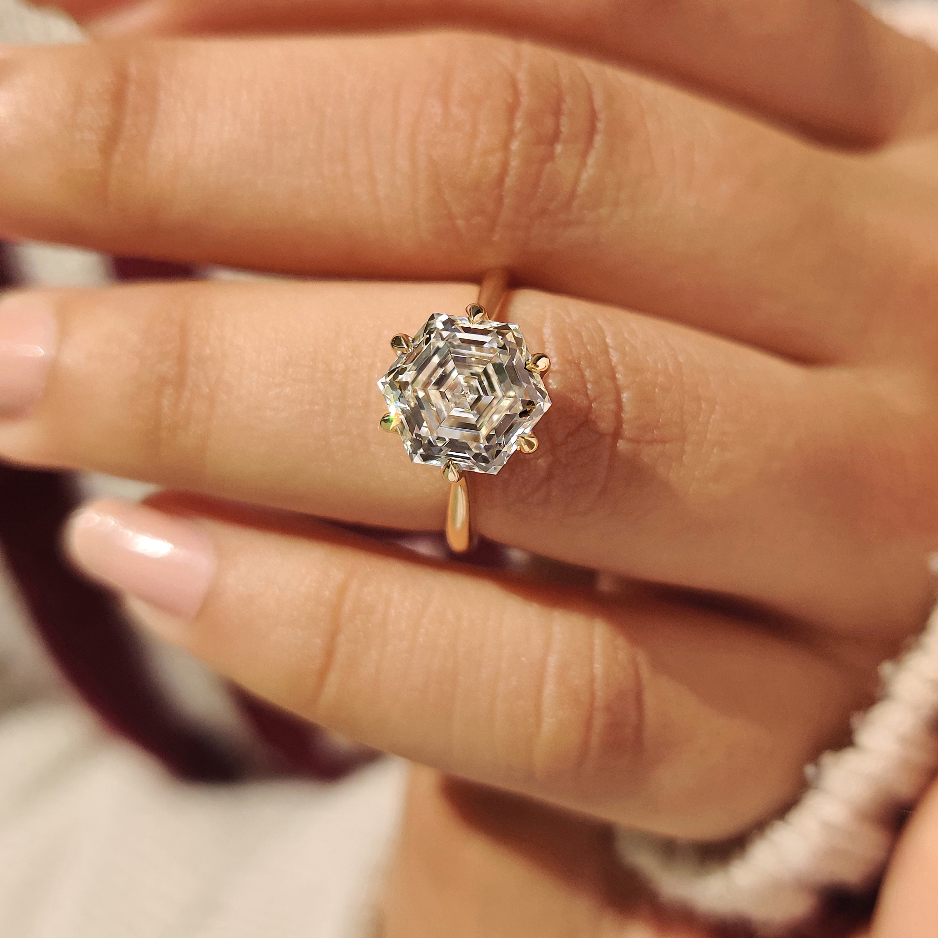 Hexagon diamond engagement ring with tulip and cathedral setting
