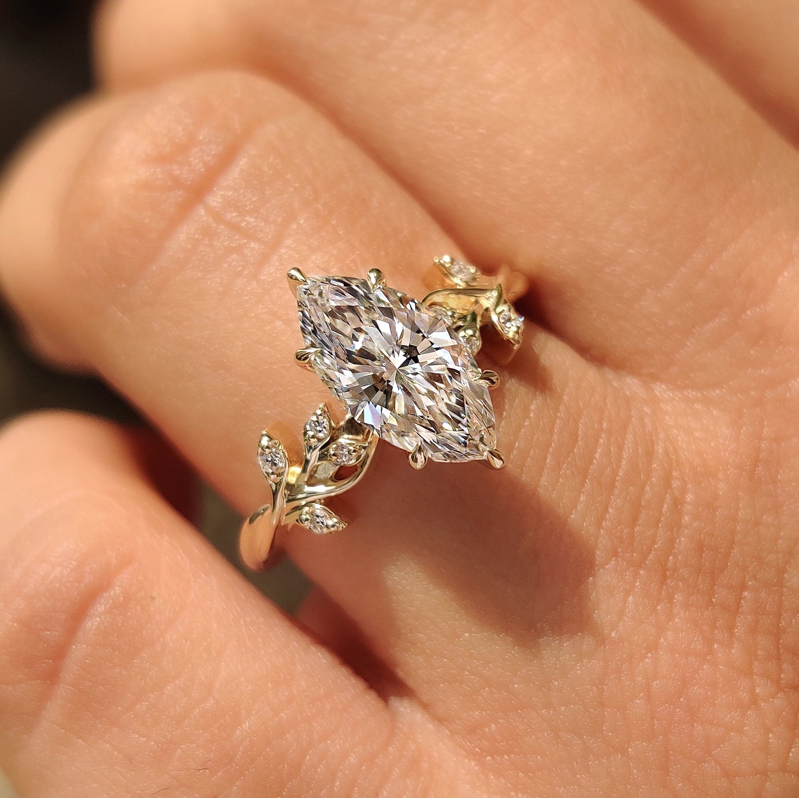Leaf and vine marquise diamond ring design.
