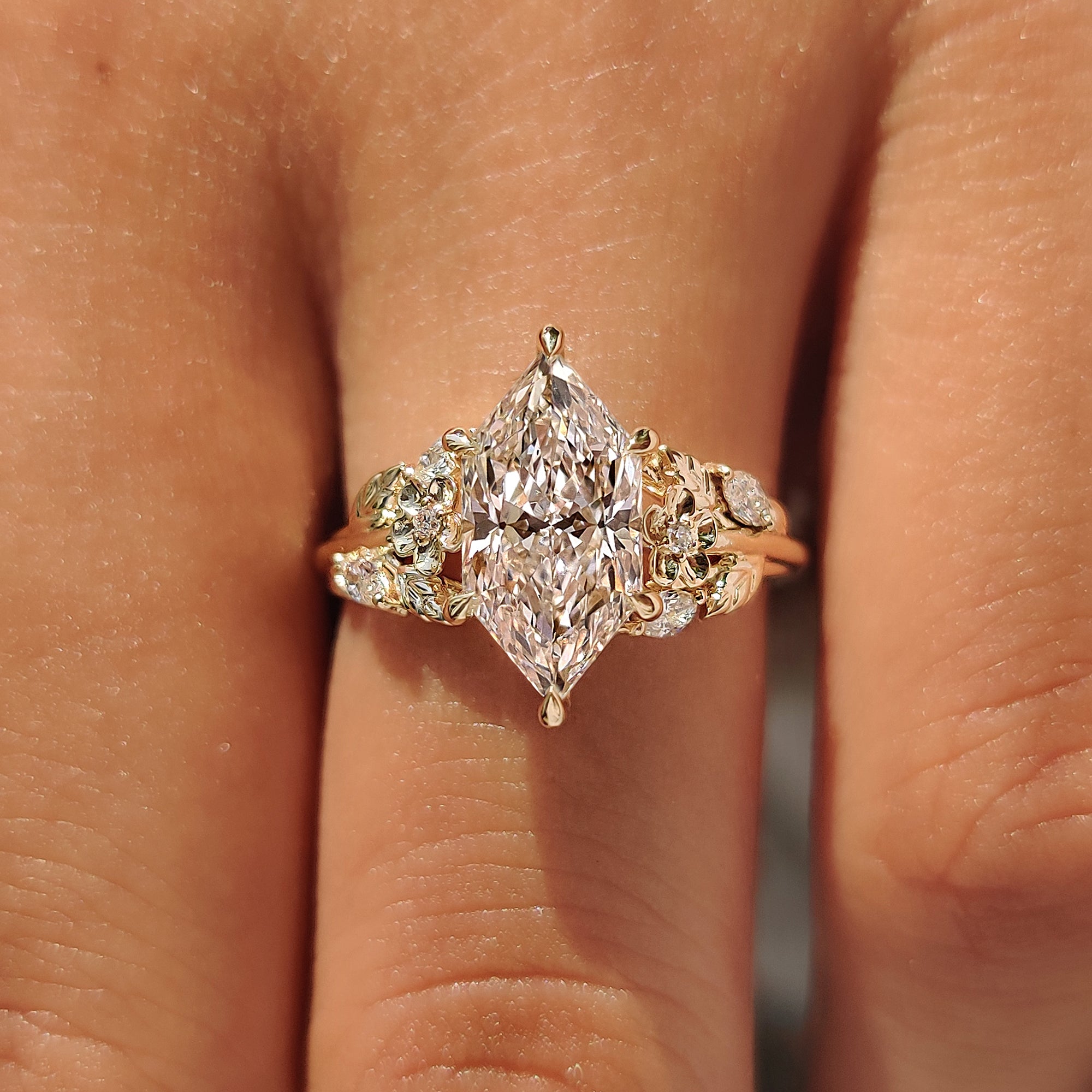 Yellow gold nature inspired engagement ring with floral detailing.
