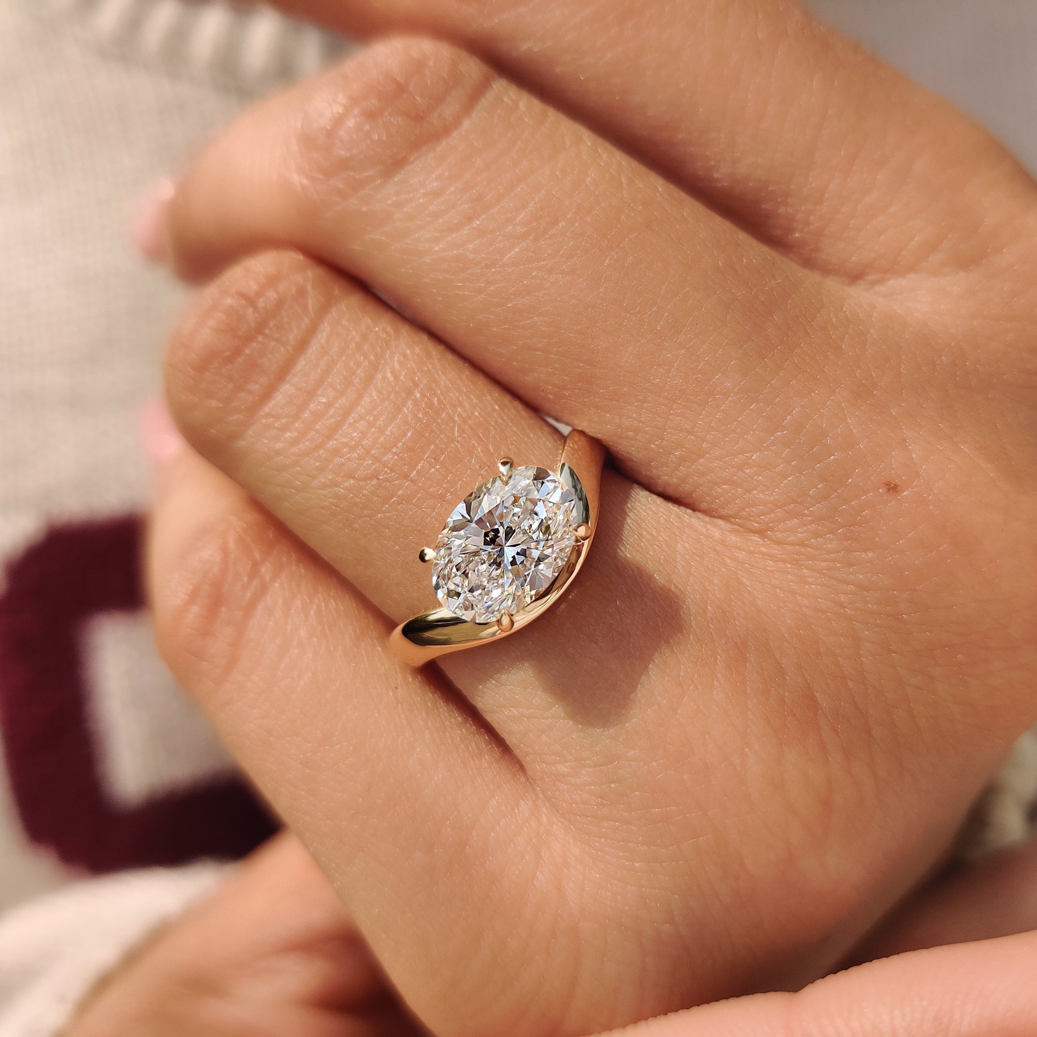 Lab grown oval cut diamond ring with east to west layout
