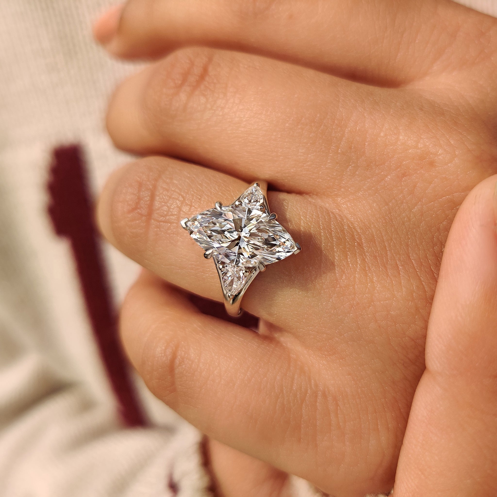 Three stone marquise diamond ring with pear side accents
