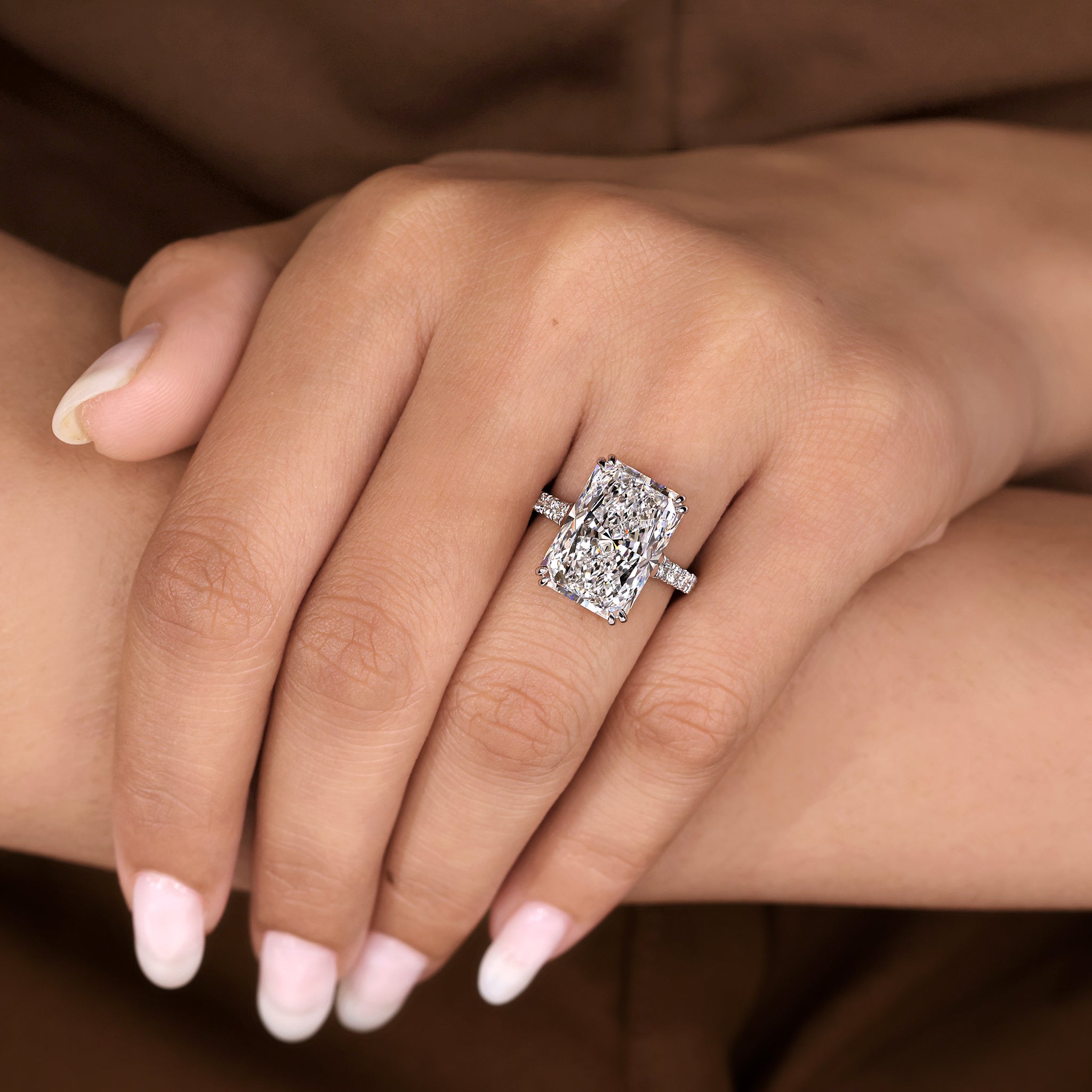 Radiant cut diamond ring with round pave band design
