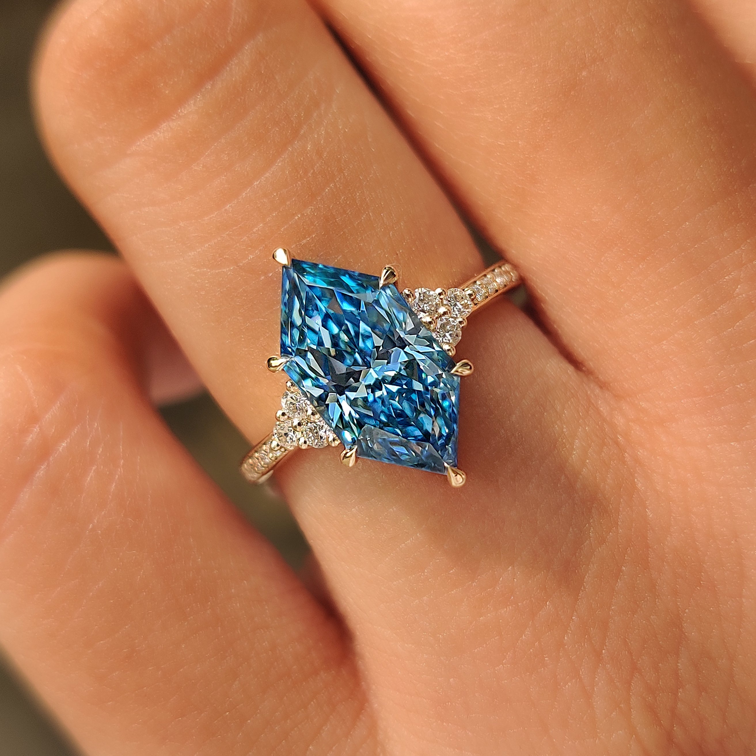 Handmade yellow gold ring with blue and white lab grown diamonds.
