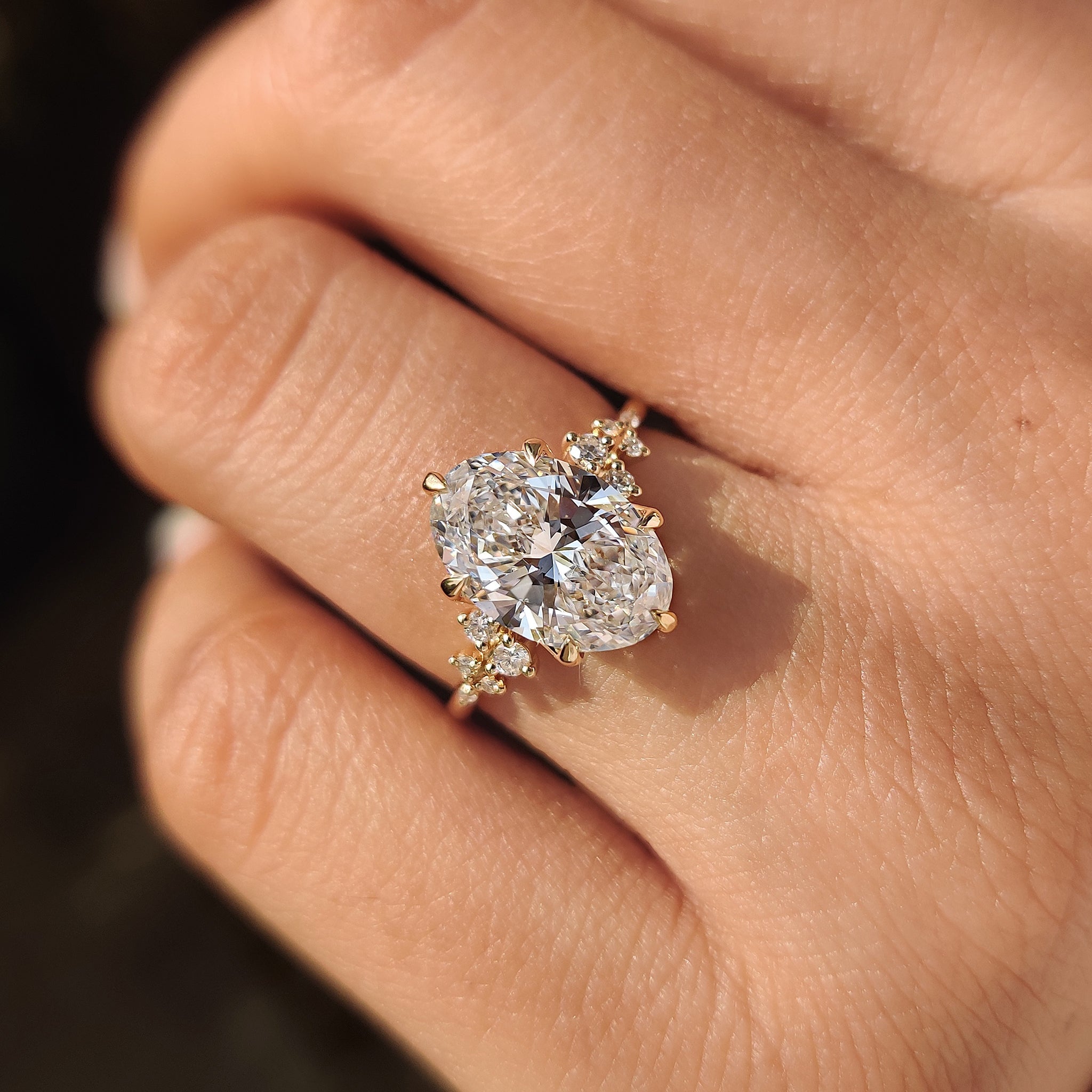 Carat Diamonds oval diamond ring with cluster setting.
