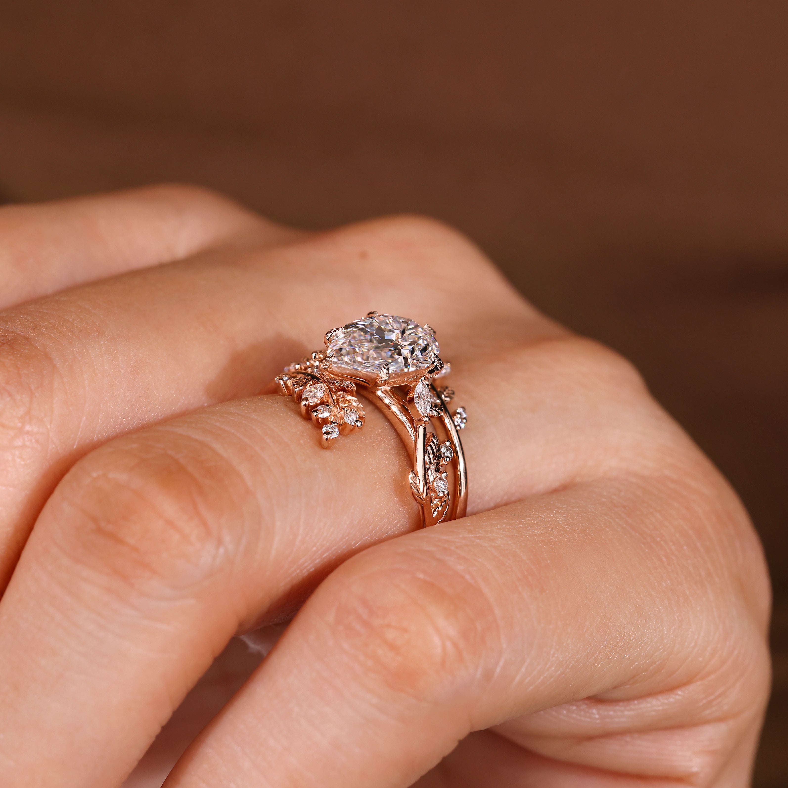 Pear diamond ring with leaf prongs and cluster setting

