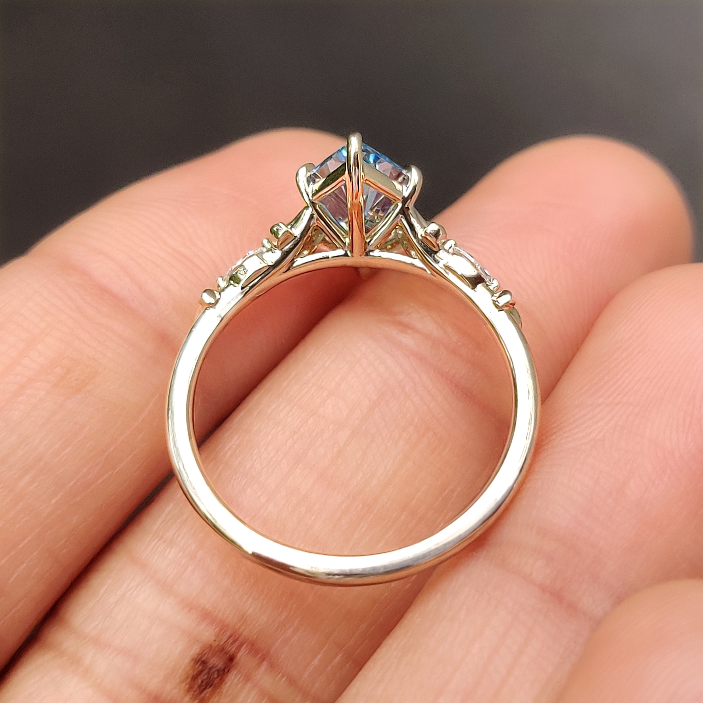Handmade marquise diamond ring with round side stone accents
