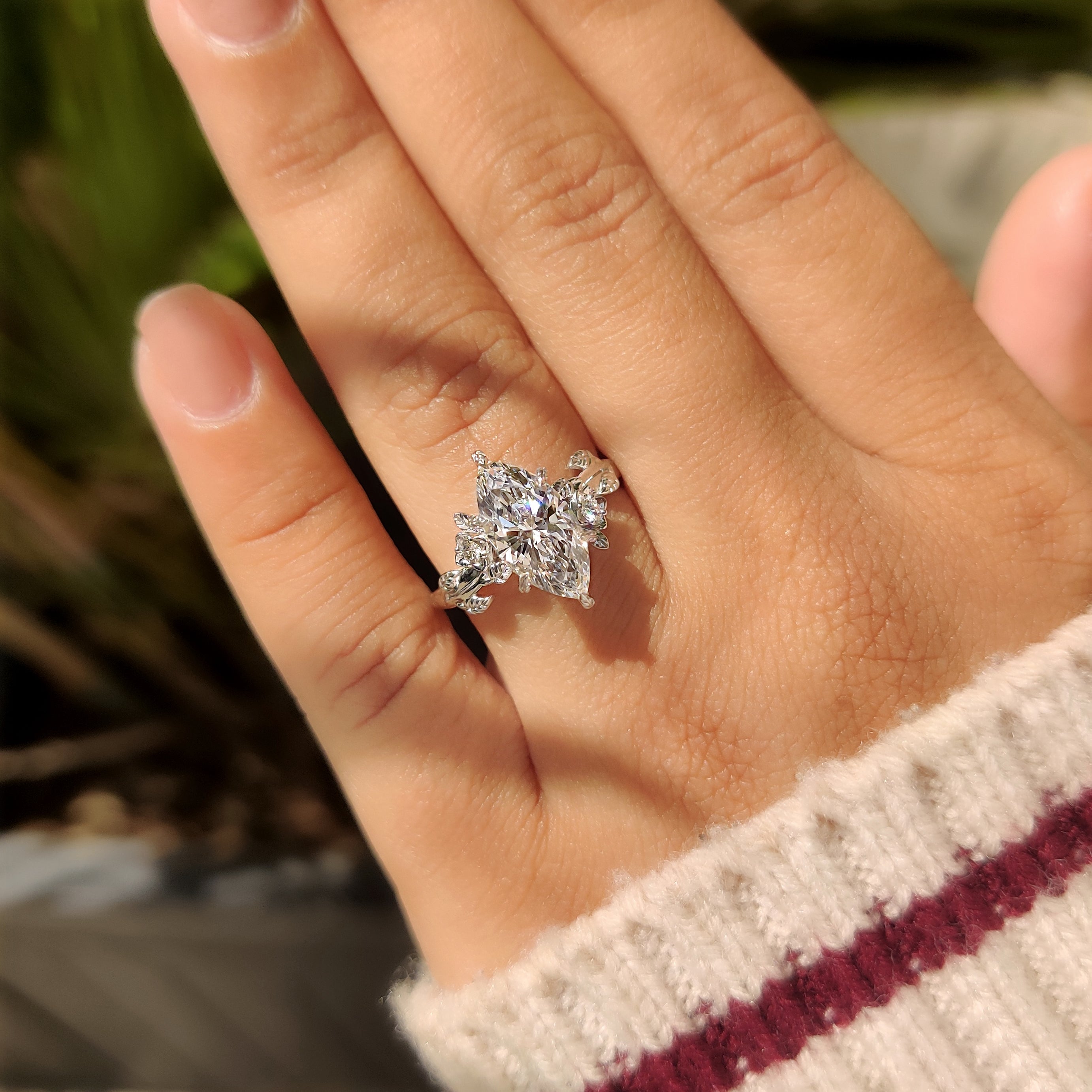 Handmade marquise diamond ring with nature inspired leaf accents.
