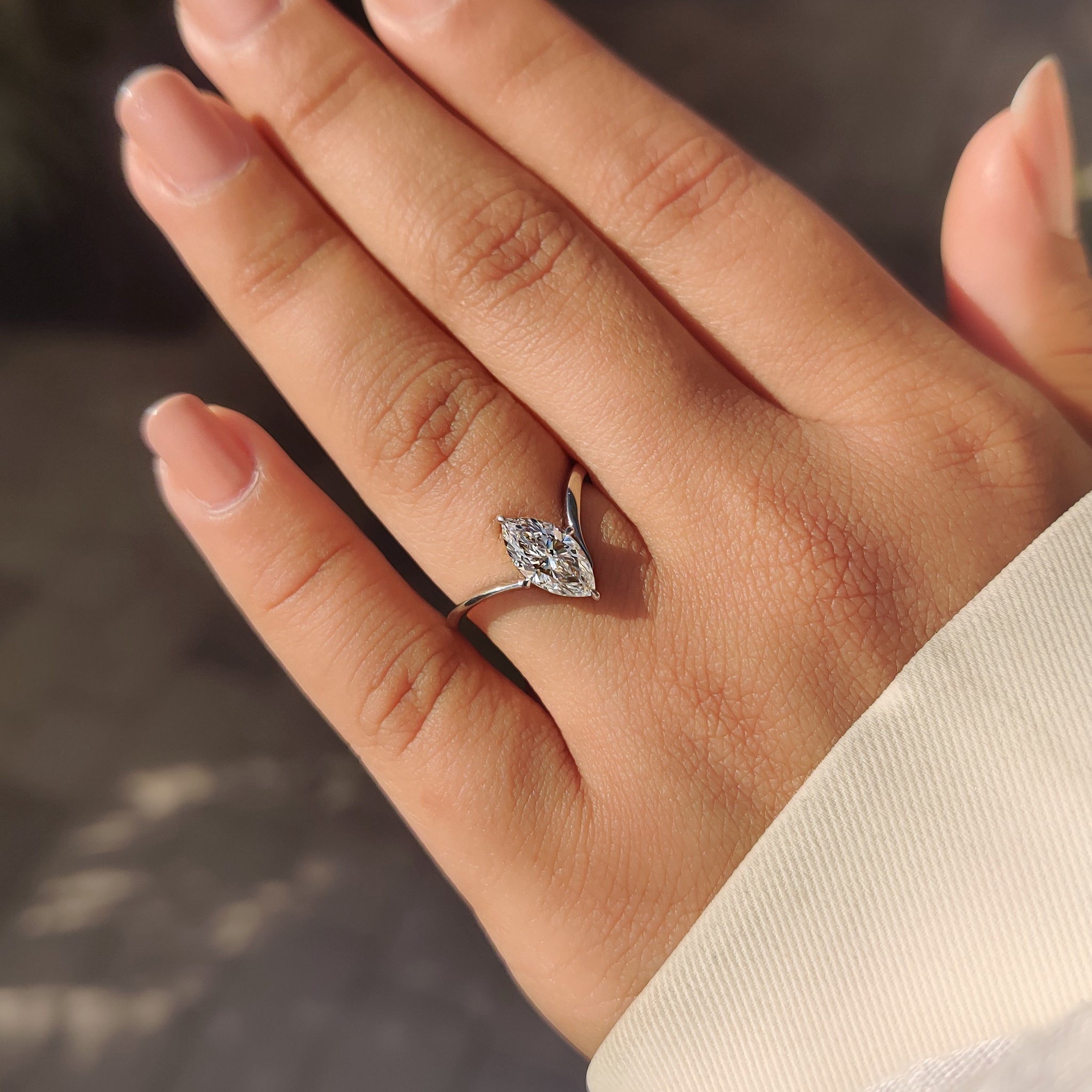 Marquise cut solitaire ring with compass claw prongs.
