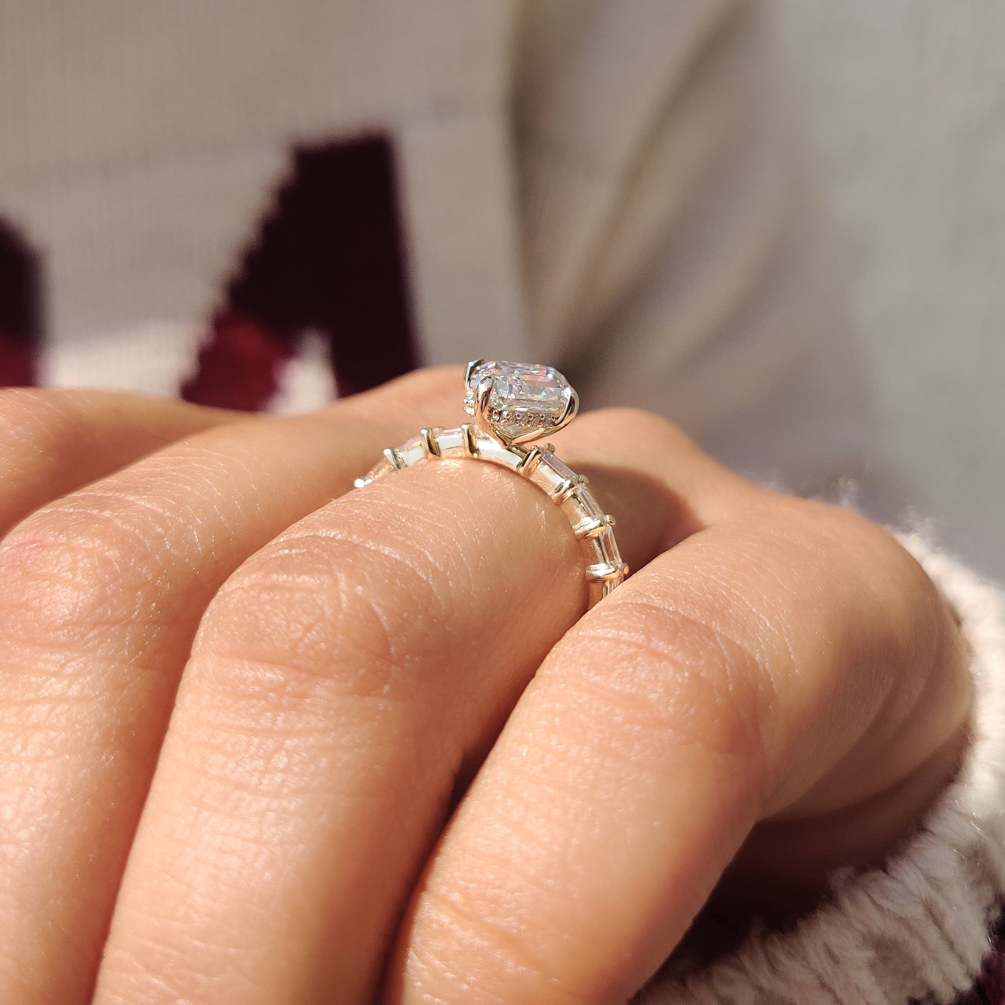 Elongated hexagon ring with round cut hidden halo detail.
