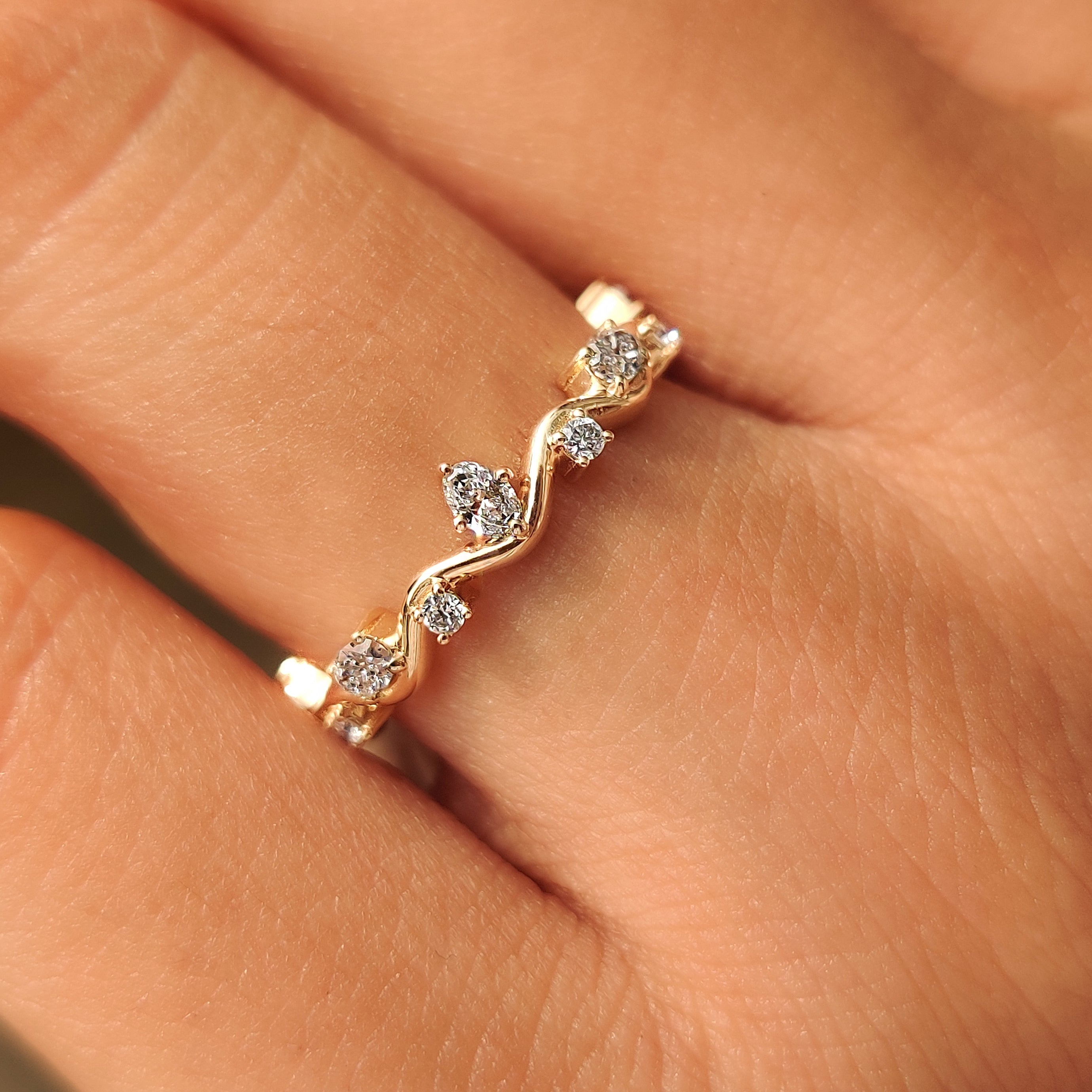 Lab grown oval and round diamonds in a fluid wave design.
