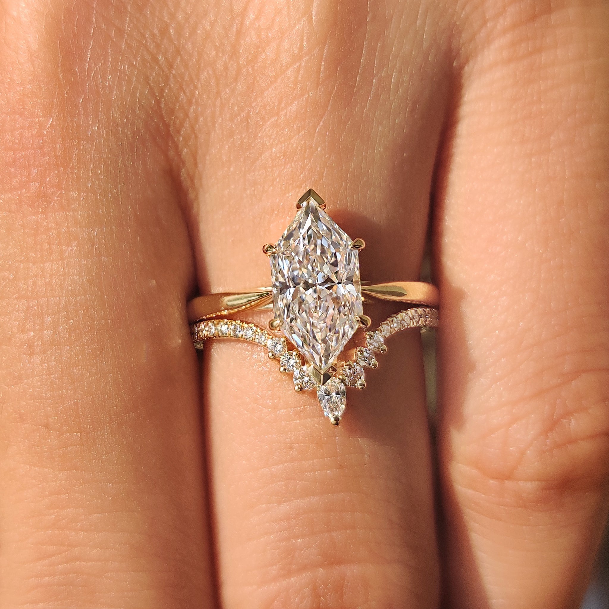 Curved style wedding band with pear and round diamonds
