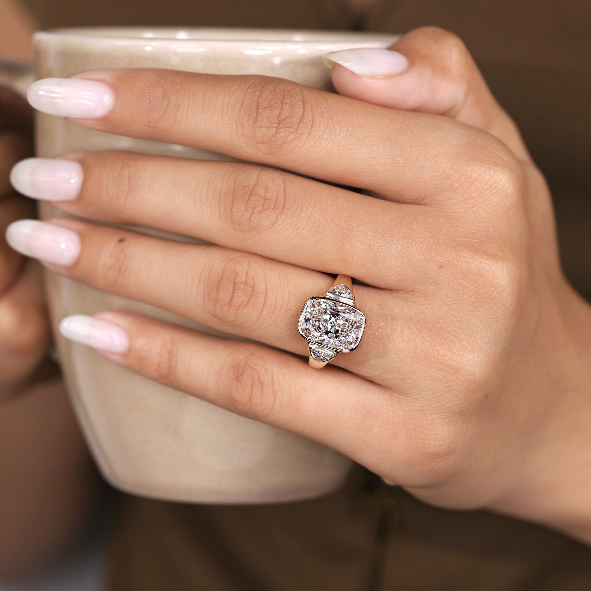 Elongated cushion cut ring with balanced trillion side stones
