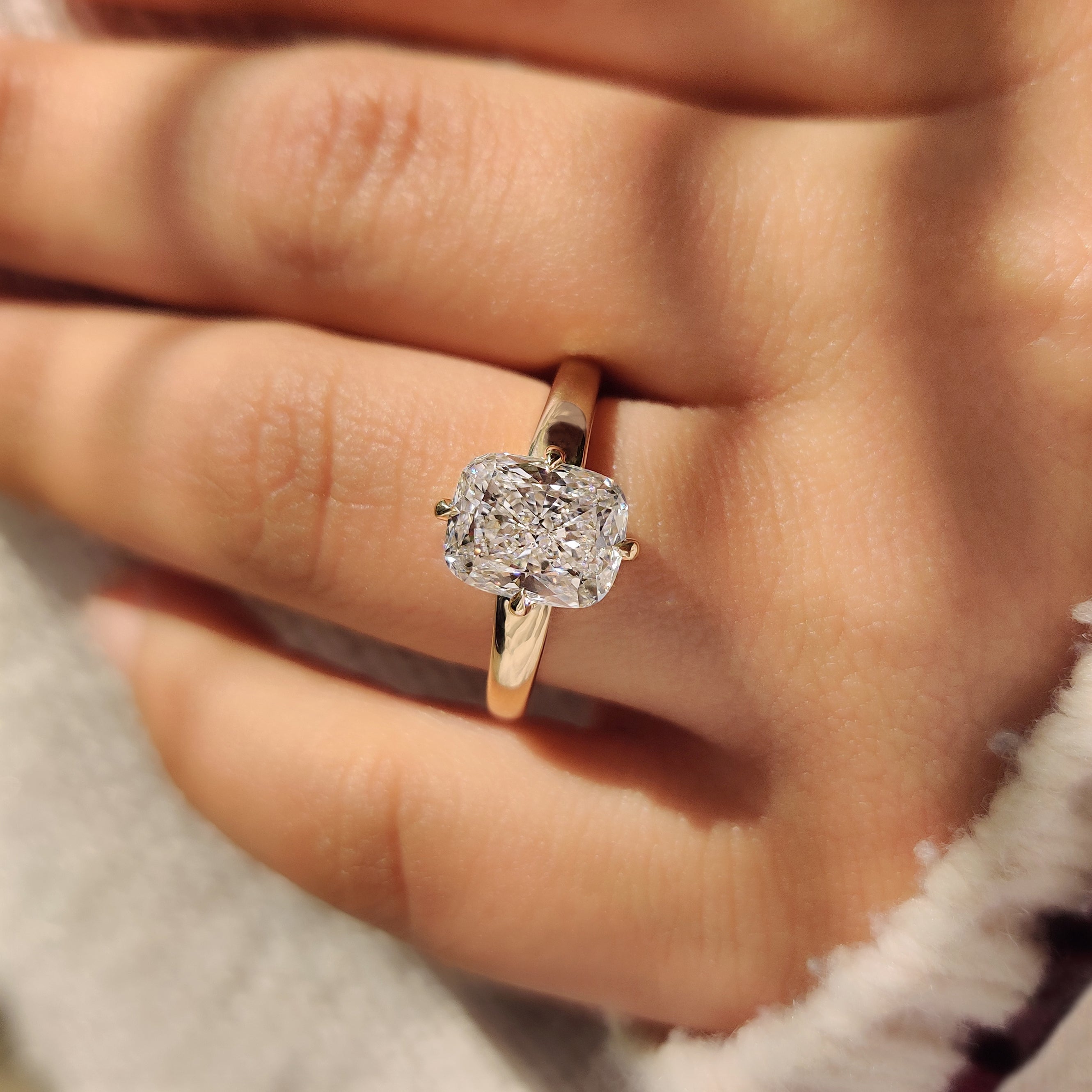 Cushion diamond ring with four compass claw prong setting
