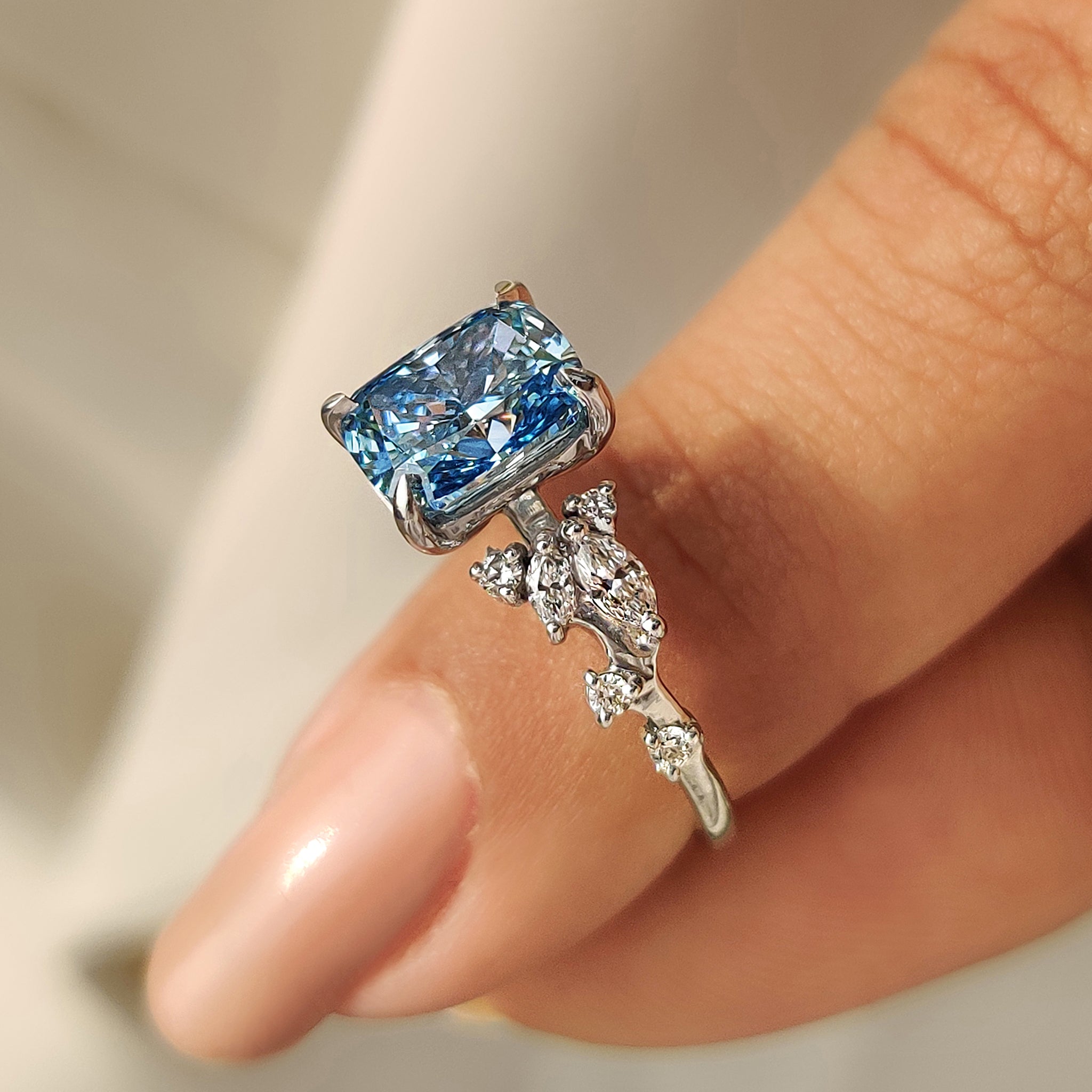 Carat Diamonds ring with blue stone in cluster style.