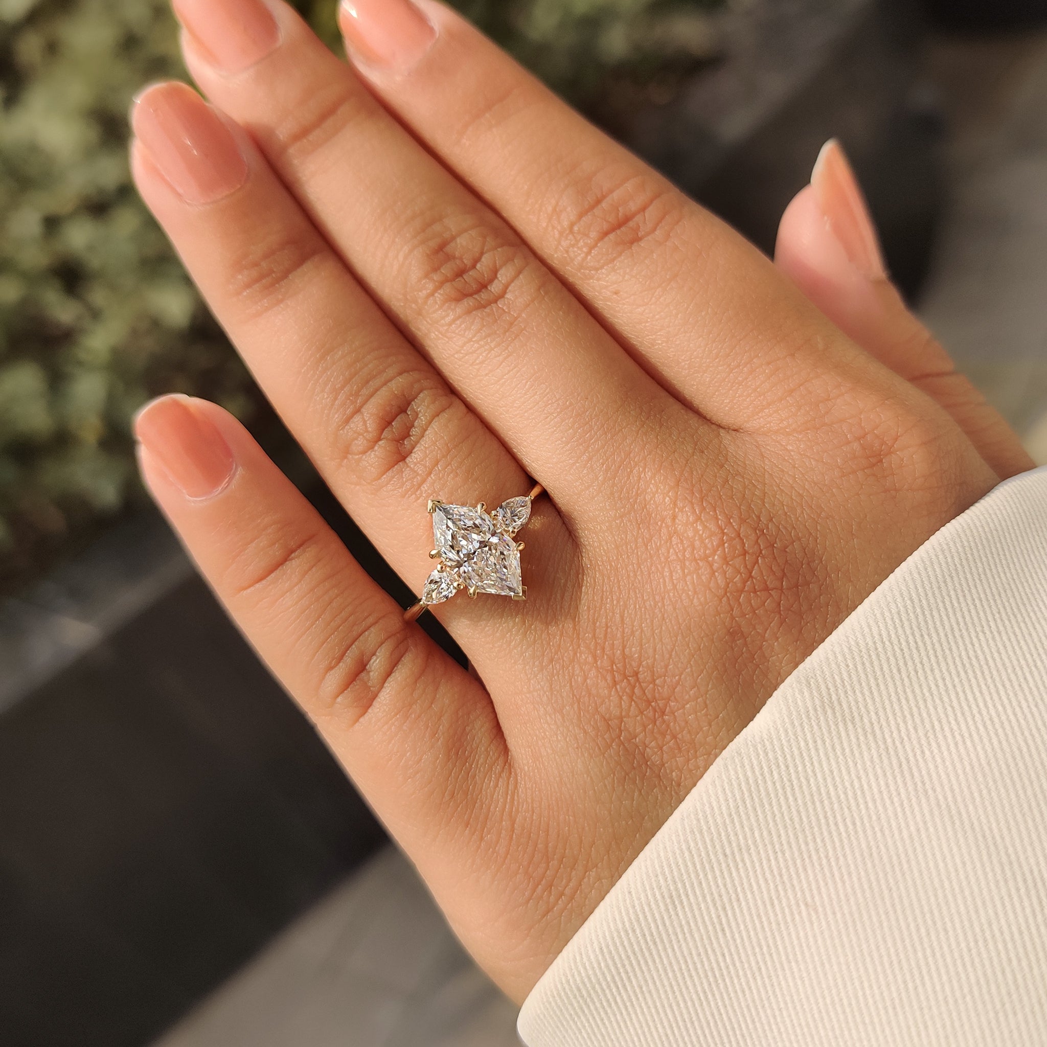 Three stone engagement ring featuring lab grown diamond
