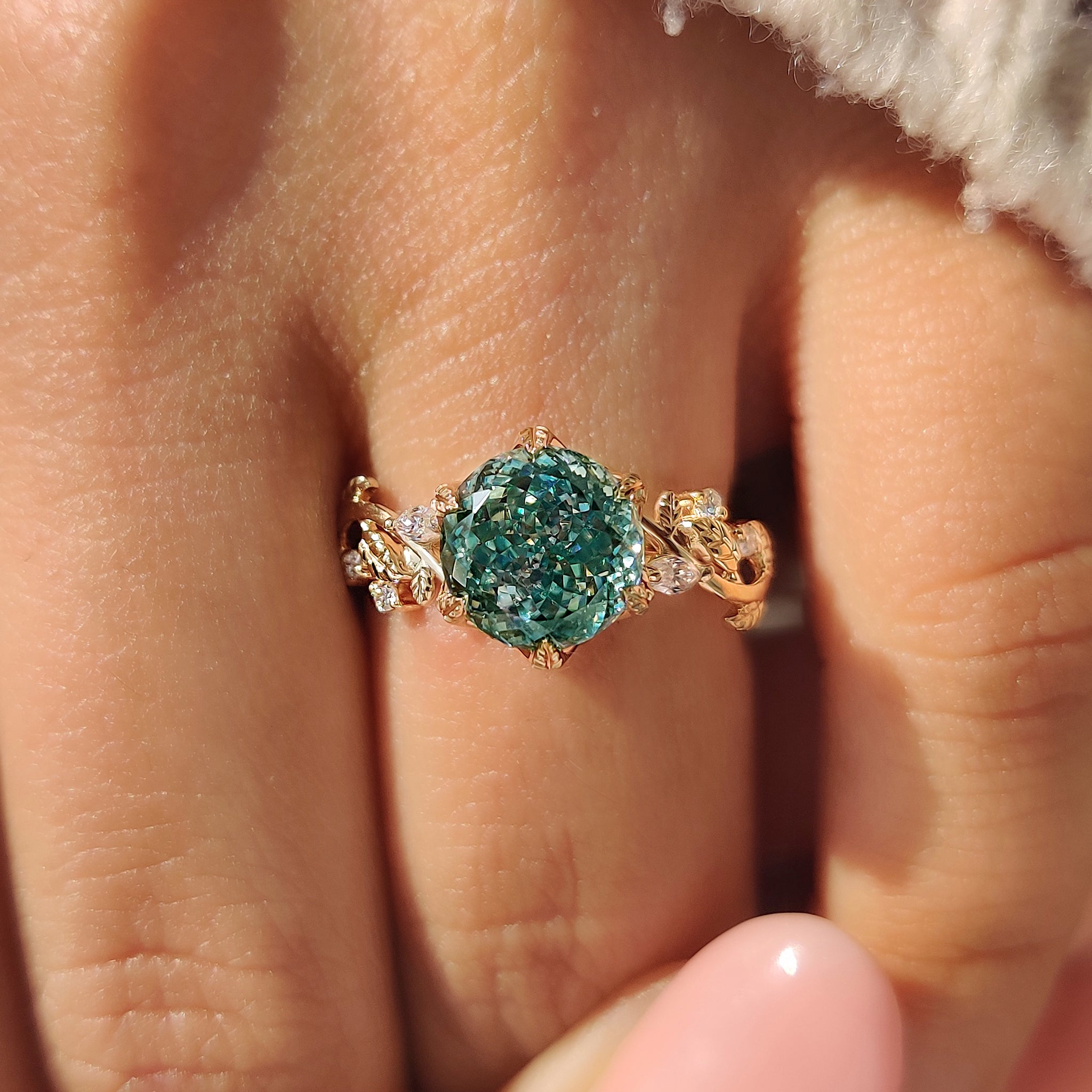 Nature inspired cyan moissanite ring with tulip setting design.
