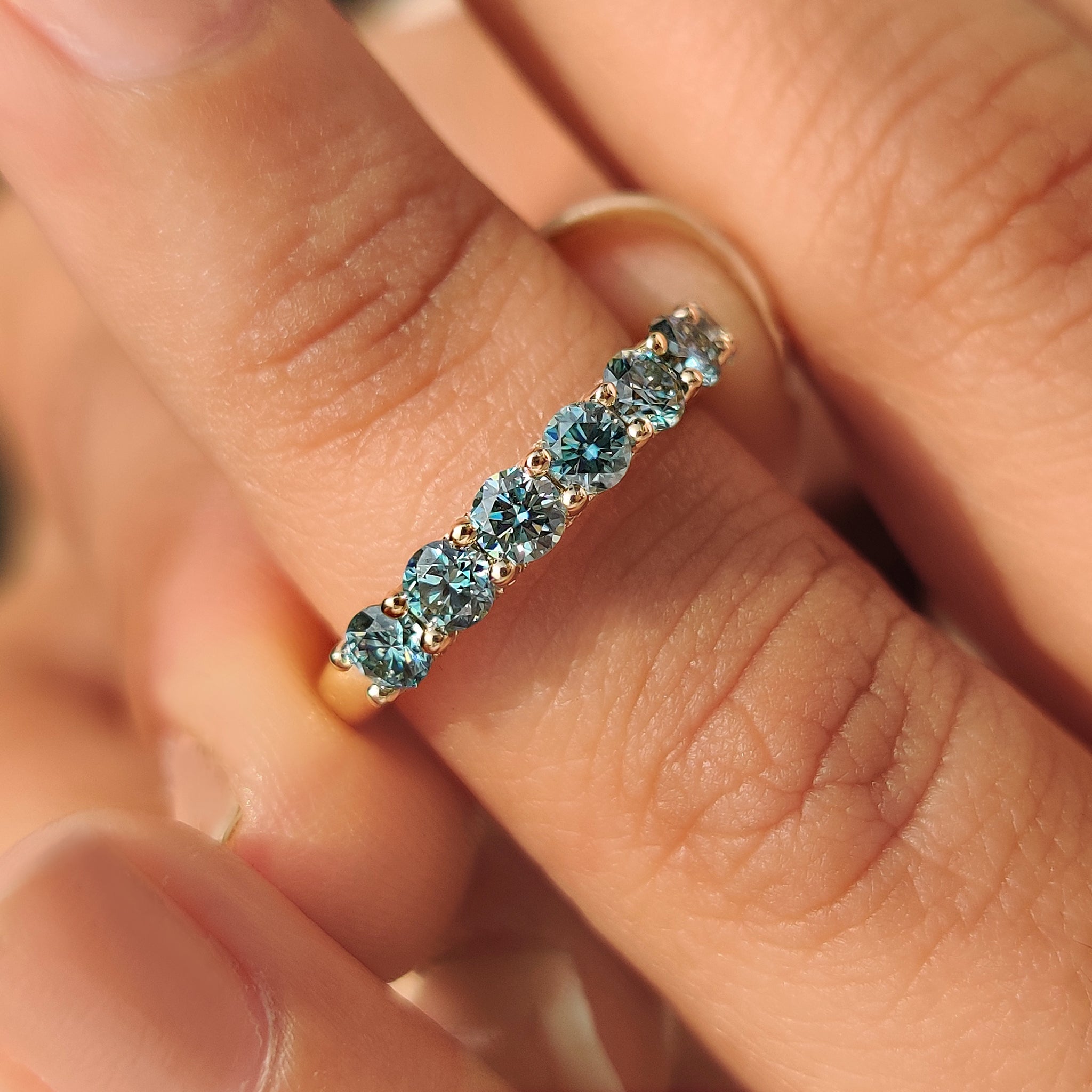 Handmade moissanite band with blue stones half eternity.
