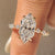 Dutch marquise engagement ring with shared prong pave band.
