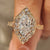 Dutch marquise diamond ring with vintage halo setting details.
