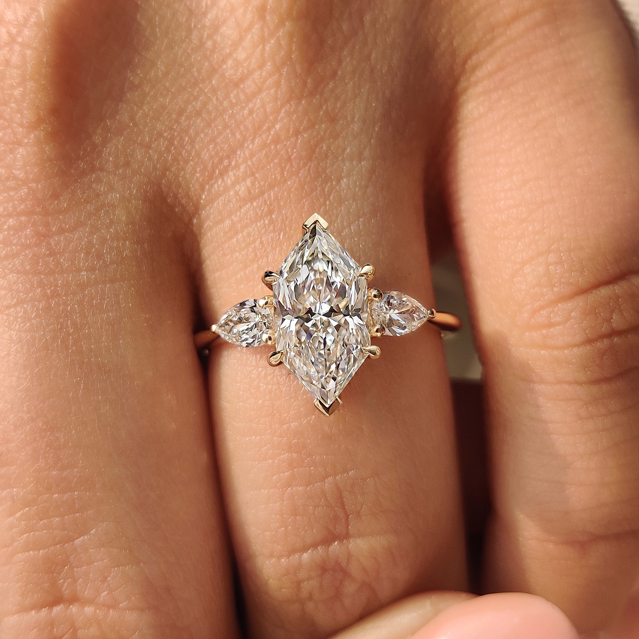 Handmade three stone engagement ring with tapered shank
