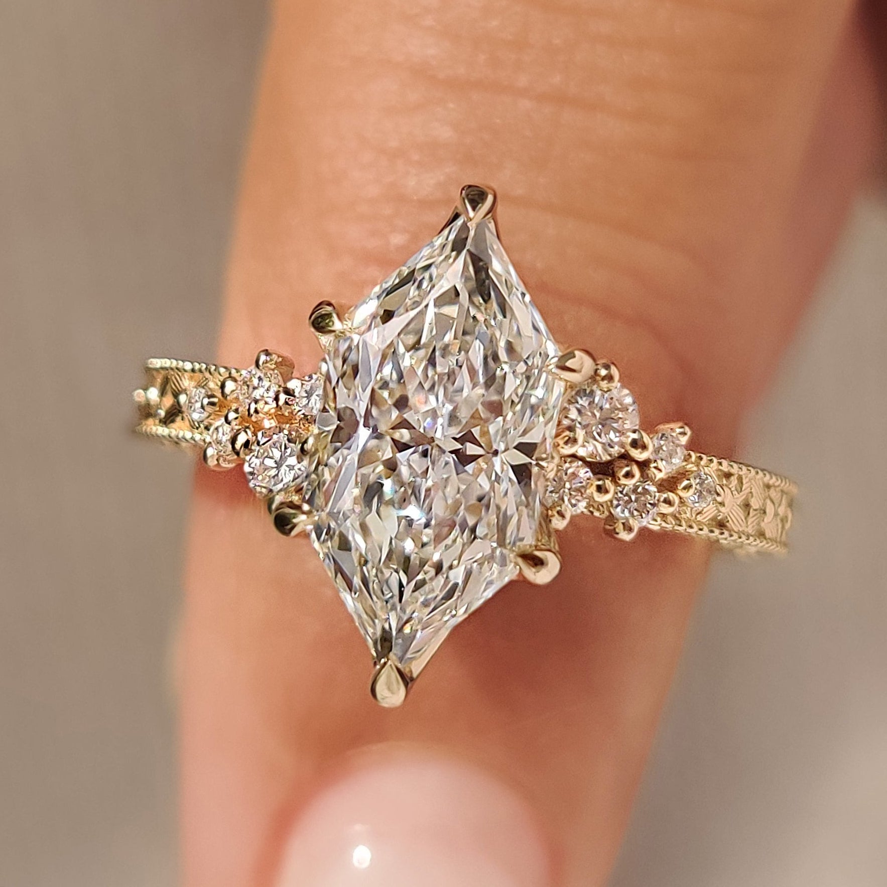 Dutch marquise diamond ring with round side stones.
