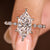 Dutch marquise engagement ring with marquise and round side stones
